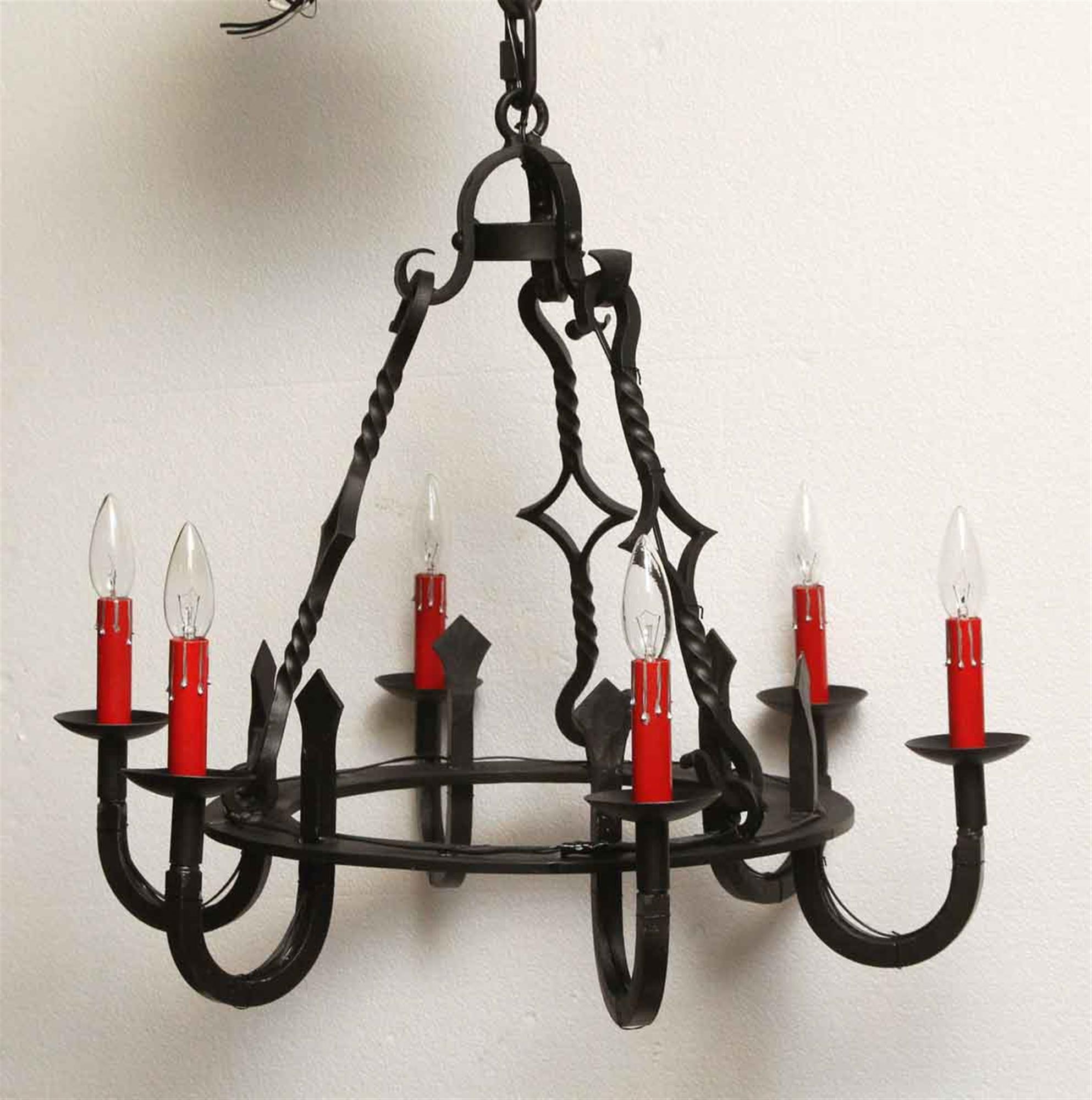 1970s wrought iron Gothic style black chandelier featuring six red candle sleeves. Matching sconces available separately. Please note, this item is located in our Los Angeles, CA location.