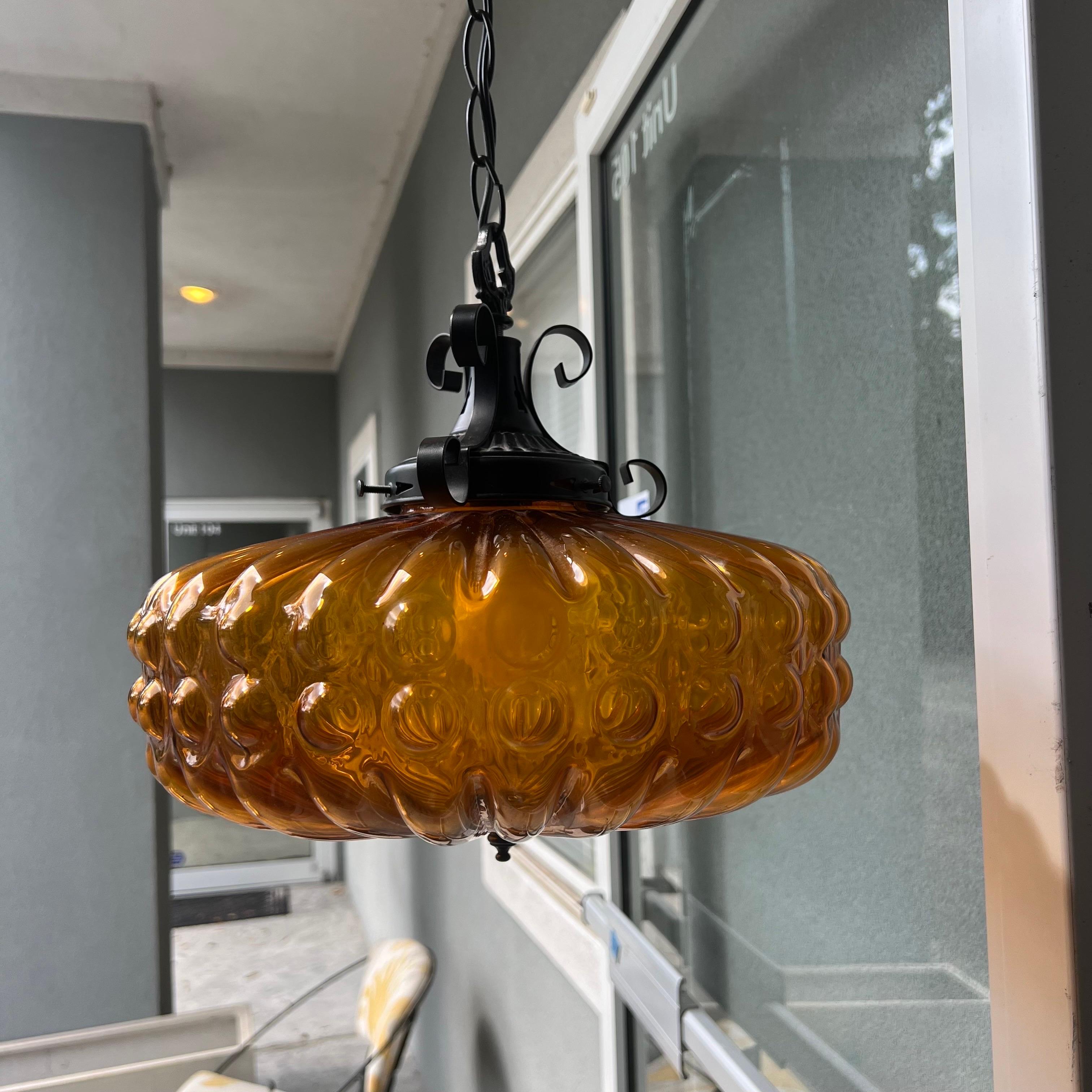 A fabulous large bubble glass pendant light with scroll work metal details on the top.  Mid-Century era with a Spanish revival twist.  This pendant light is big enough to use as a chandelier in a small entrance, over a kitchen table, etc.  