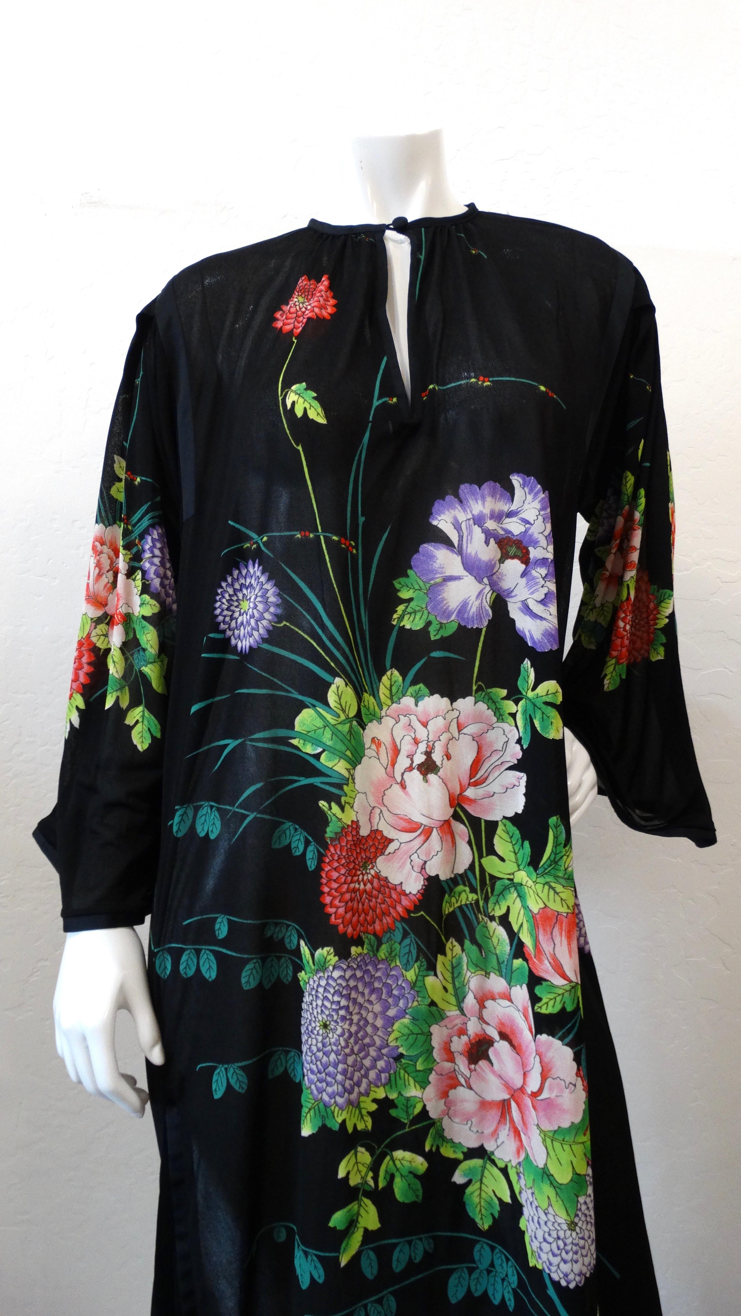 The trends of the 1970s are back in full force! Rock a piece from the original era with our graphic floral dress from Israeli designer Gottex! Bright floral graphic print on a solid black background. Open, airy peasant sleeve style silhouette.