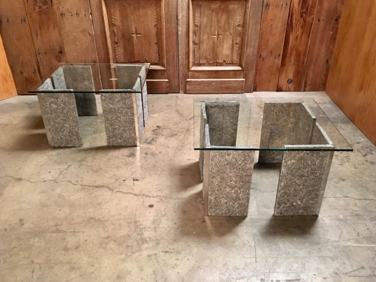 Chiseled granite conjoined with chrome corners and floating glass top end tables.