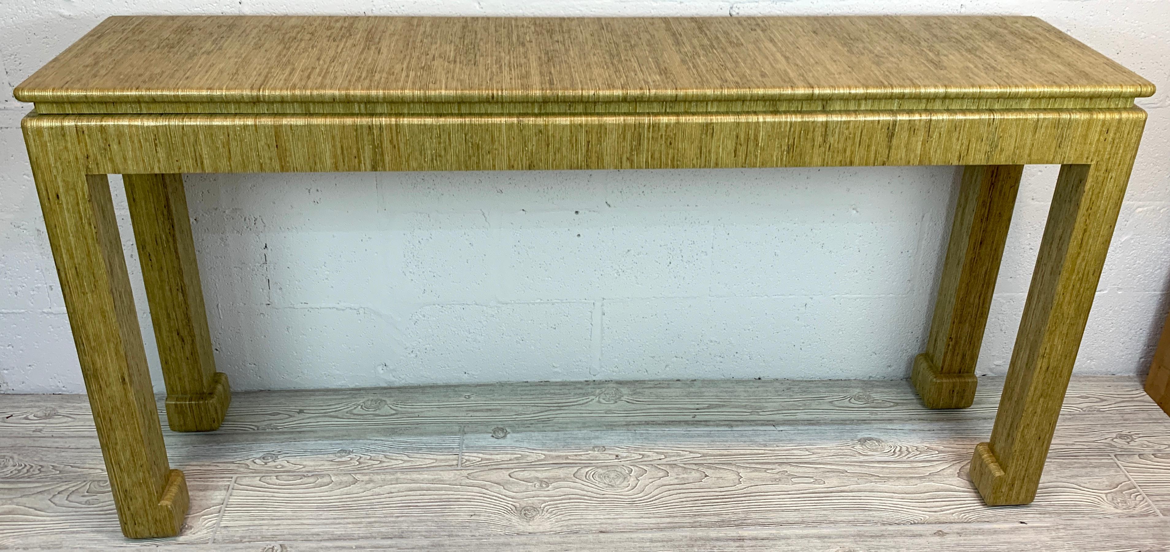 1970s GrassCloth Parsons console table in the style of Karl Springer, of the best quality, beautiful lacquered grasscloth, raised on four straight legs with reverse 'sabot' feet.
