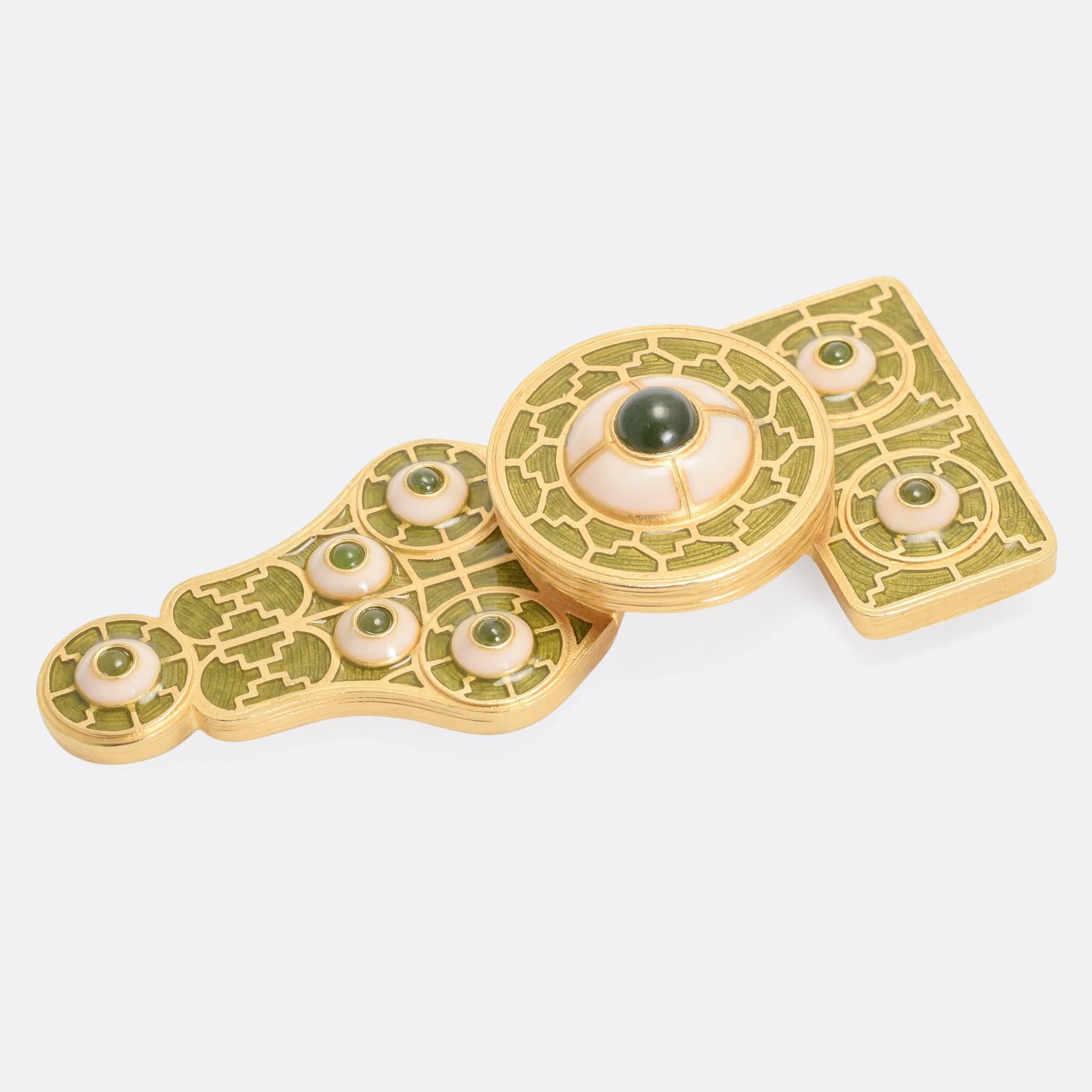 A wonderfully unusual vintage brooch by Liberty of London. The piece is large scale, and modelled as a stylized form of the Anglo-Saxon Great Square Headed Brooch, with Frankish style enamel inlays. The overall aesthetic of the piece is clearly