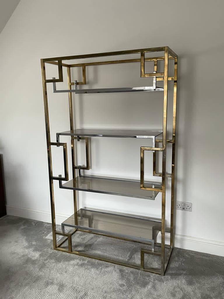 This 1970s French étagère, in chrome and brass plated steel with smoke glass shelves would make a great display cabinet or bookcase. The Greek key design is reminiscent of étagères and tables by French designer Guy Lefevre for Maison Jansen