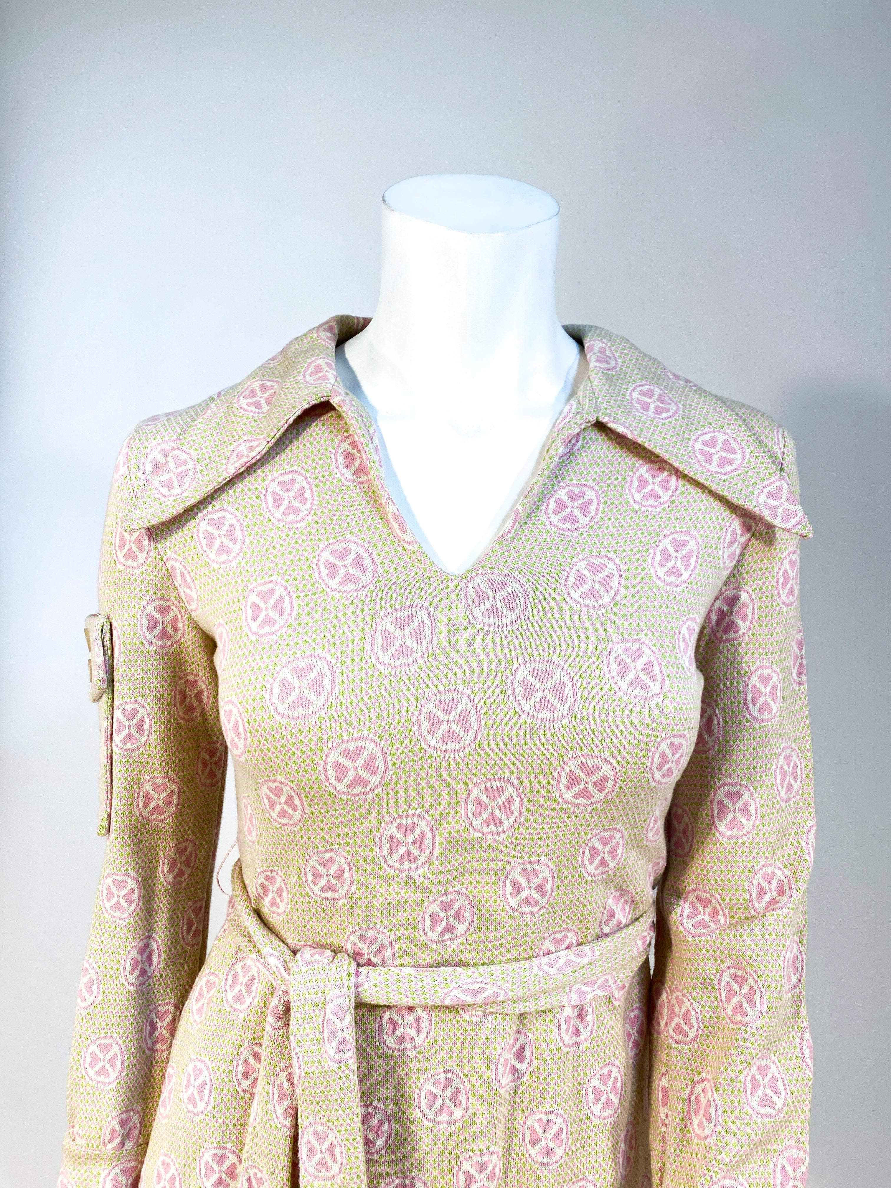 1970s very soft green and pink knit cotton mini dress with enlarged collar, full length sleeves, wide cuffs, matching sash belt, and a usable patch pocket on the top of the right sleeve. The back has a metal zipper closure with hooks and eyes.