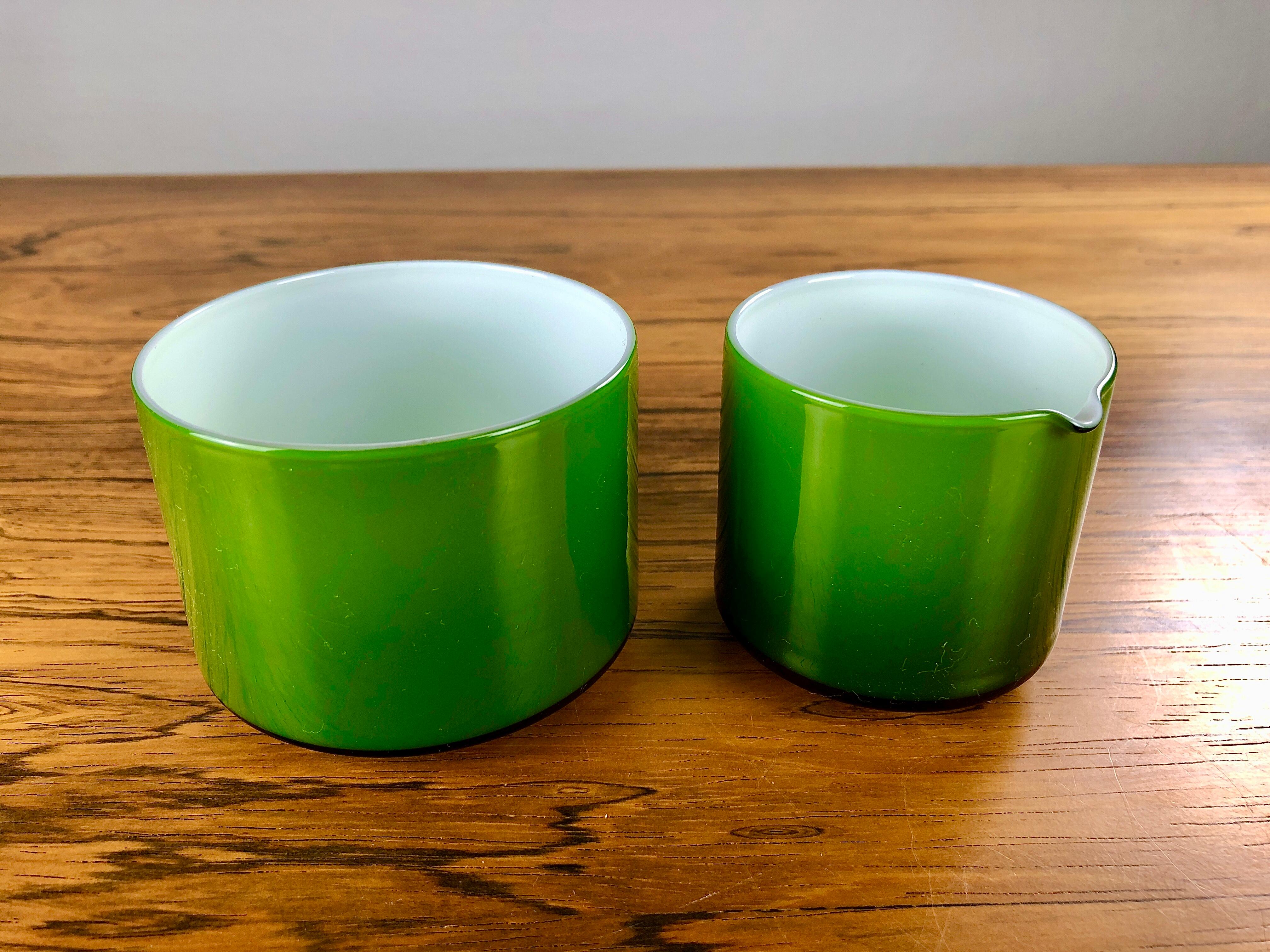 Set of green creamer and sugar bowls in glass, designed by Michael Bang and produced by Holmegaard in the 1970s.

The well designed set with it´s 1970´s colors is in very good condition.

Michael Bang (1942-2013) was the son of Jacob E. Bang,