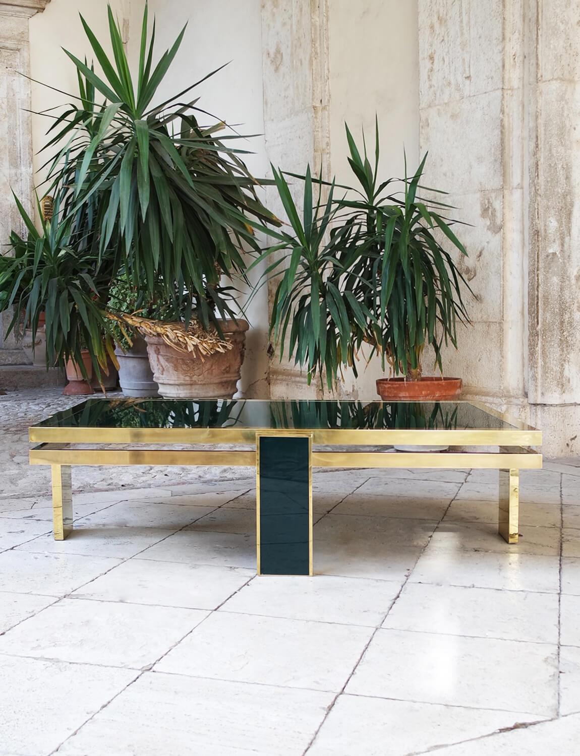 An exceptional piece of Italian design history. Liwans 1970s dark green glass and brass coffee table found in Italy. This spectacular mid-century modern design piece was made by the renowned designer, Giacomo Sinopoli for Liwans, the Roman furniture