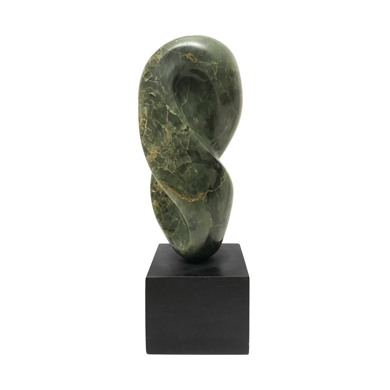 Green marble abstract sculpture on square wood base. USA. 1970s.