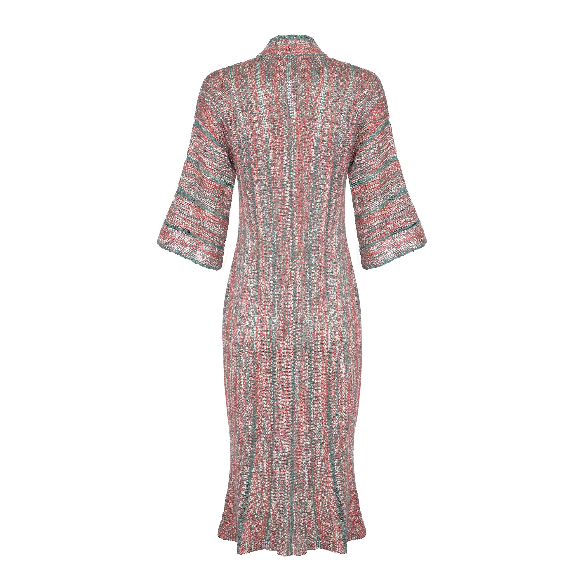 A 1970s Mary Farrin knitted dress. This is a really versatile piece from renowned British knitwear designer Mary Farrin in a wonderful combination of deep sea foam green, coral pink and white wool acrylic. The style is gently fitted and this dress