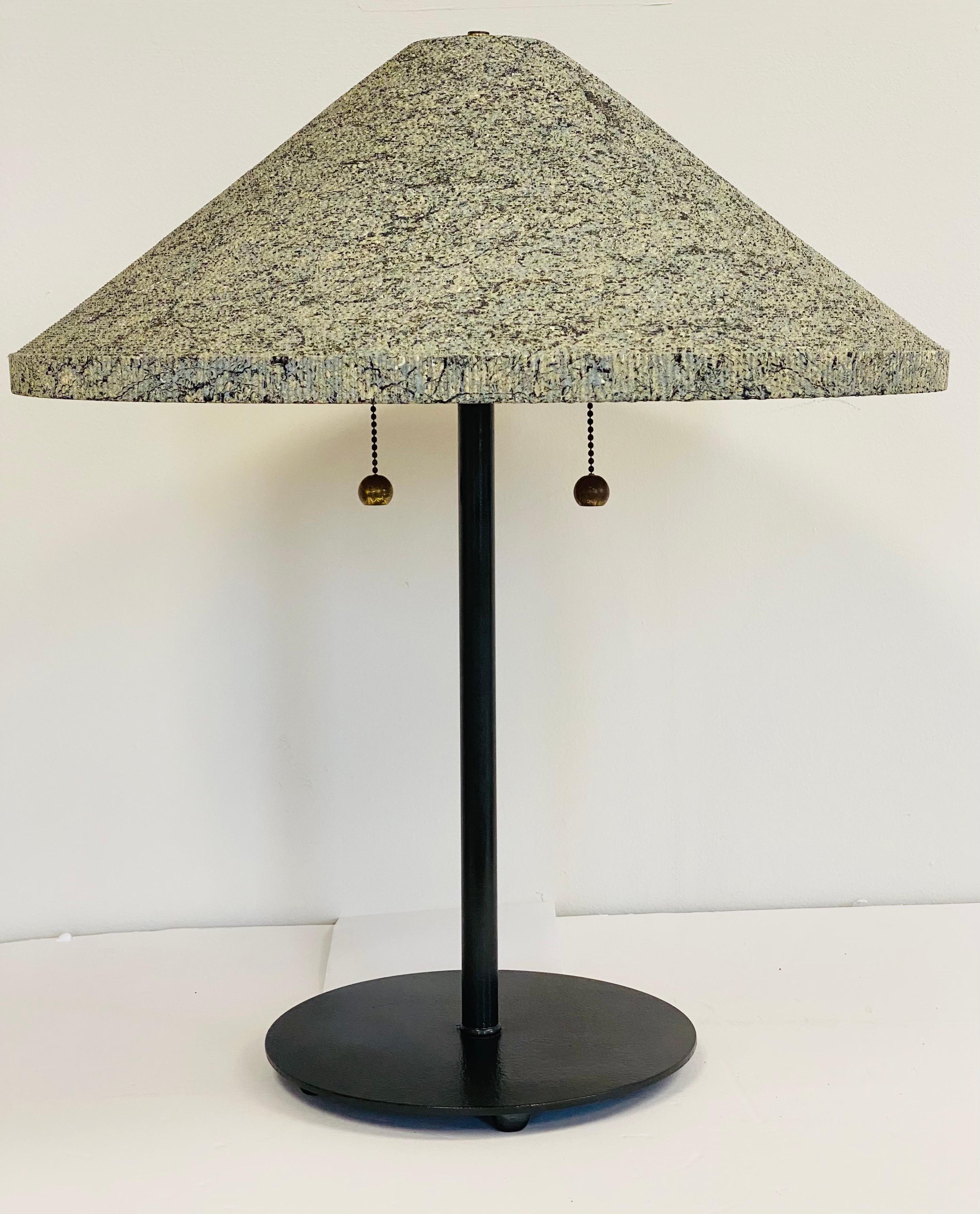 We are very pleased to offer a whimsical table lamp designed by Gregory Van Pelt, circa the 1970s. Defined by its distinctive mix of materials, this table lamp will make a modern statement. Its sleek body is crafted from metal and the cone shade is