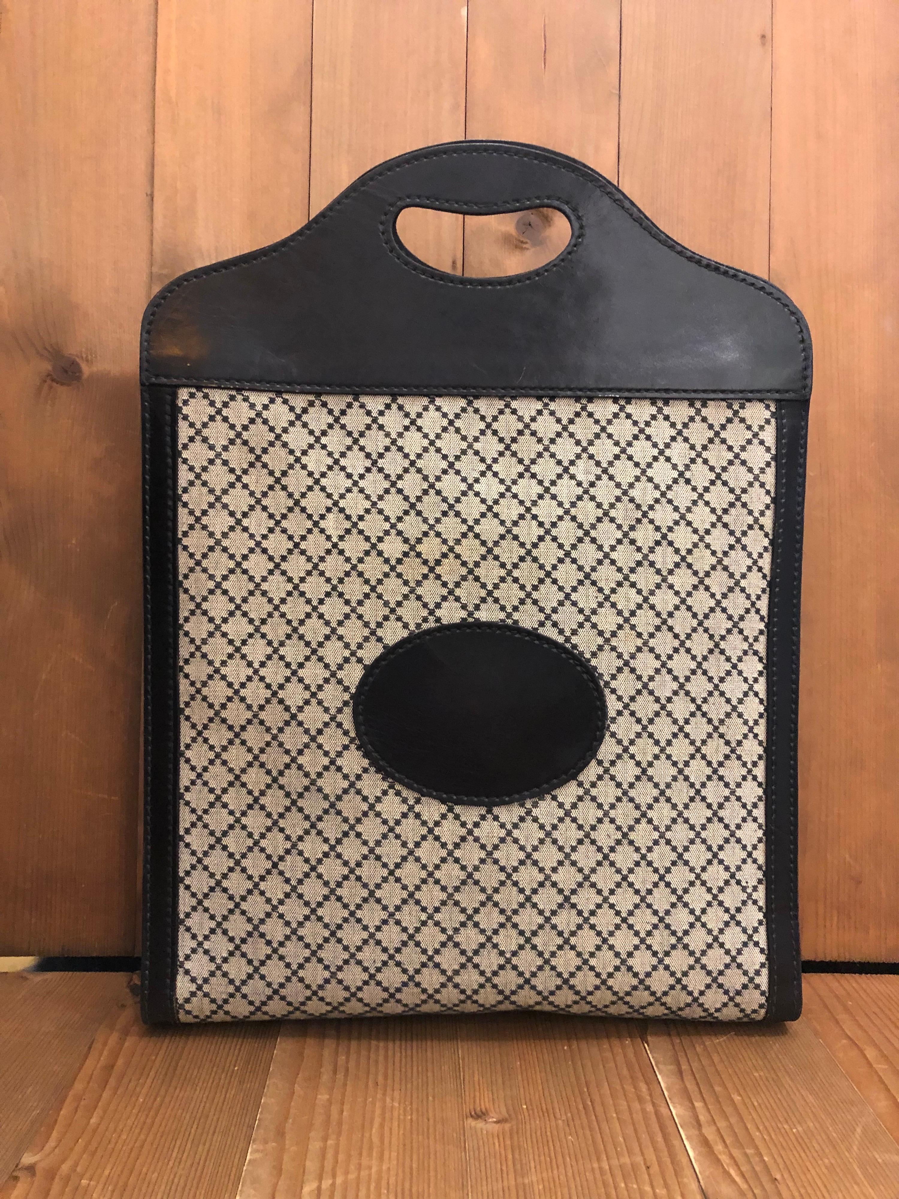 1970s Gucci book tote in Gucci iconic black diamanté jacquard and leather. Made in Italy. Measures approximately 13.5 x 18 x 2.75 inches 

Condition: Minor signs of wear. Generally in good condition 

Outside: Minor marks on jacquard and leather