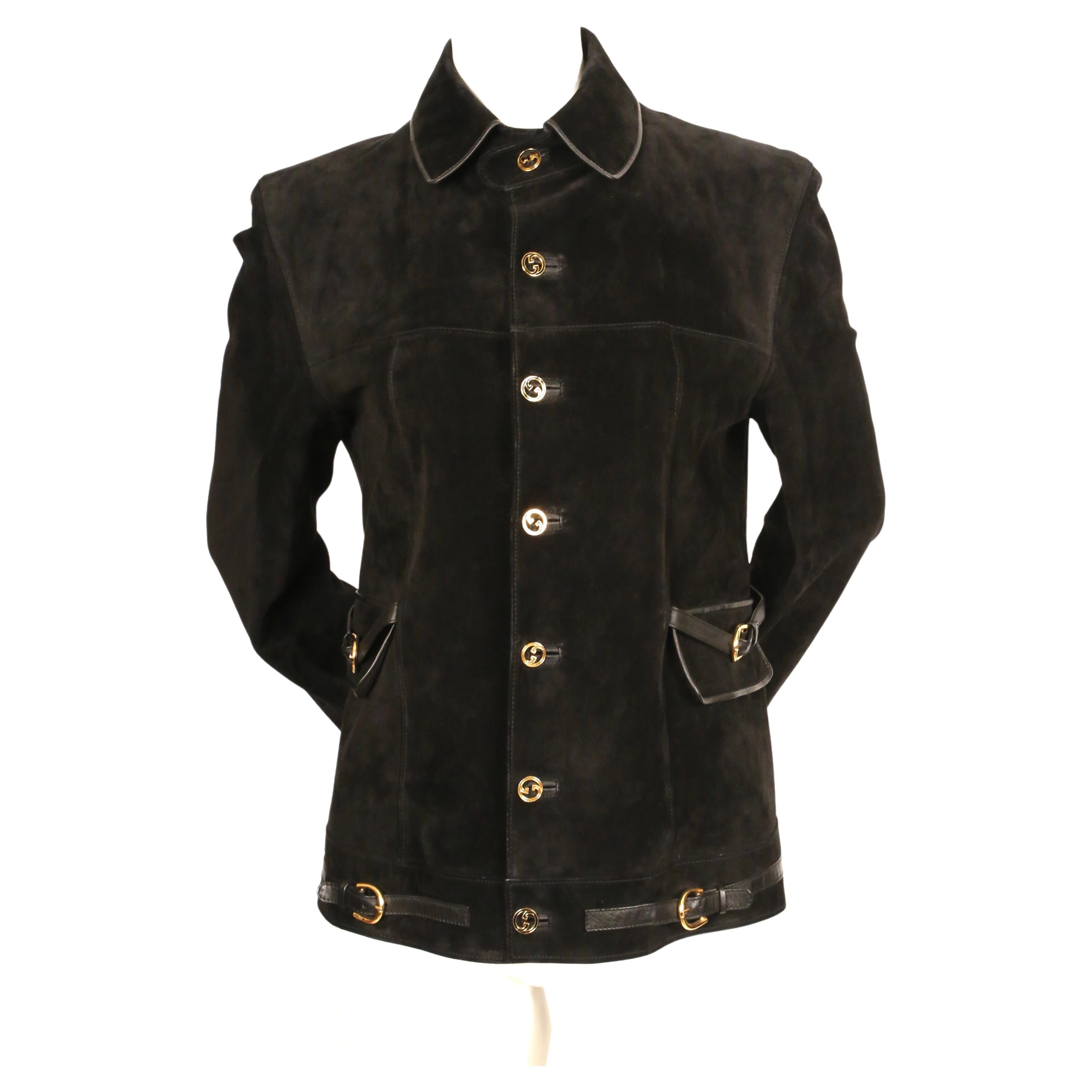 Black suede jacket with gilt hardware, buckles and leather trim from Gucci dating to the 1970's. This jacket is labeled a size 50 so it was probably originally a men's jacket although it fits a woman as well. Jacket was not clipped on the size 2