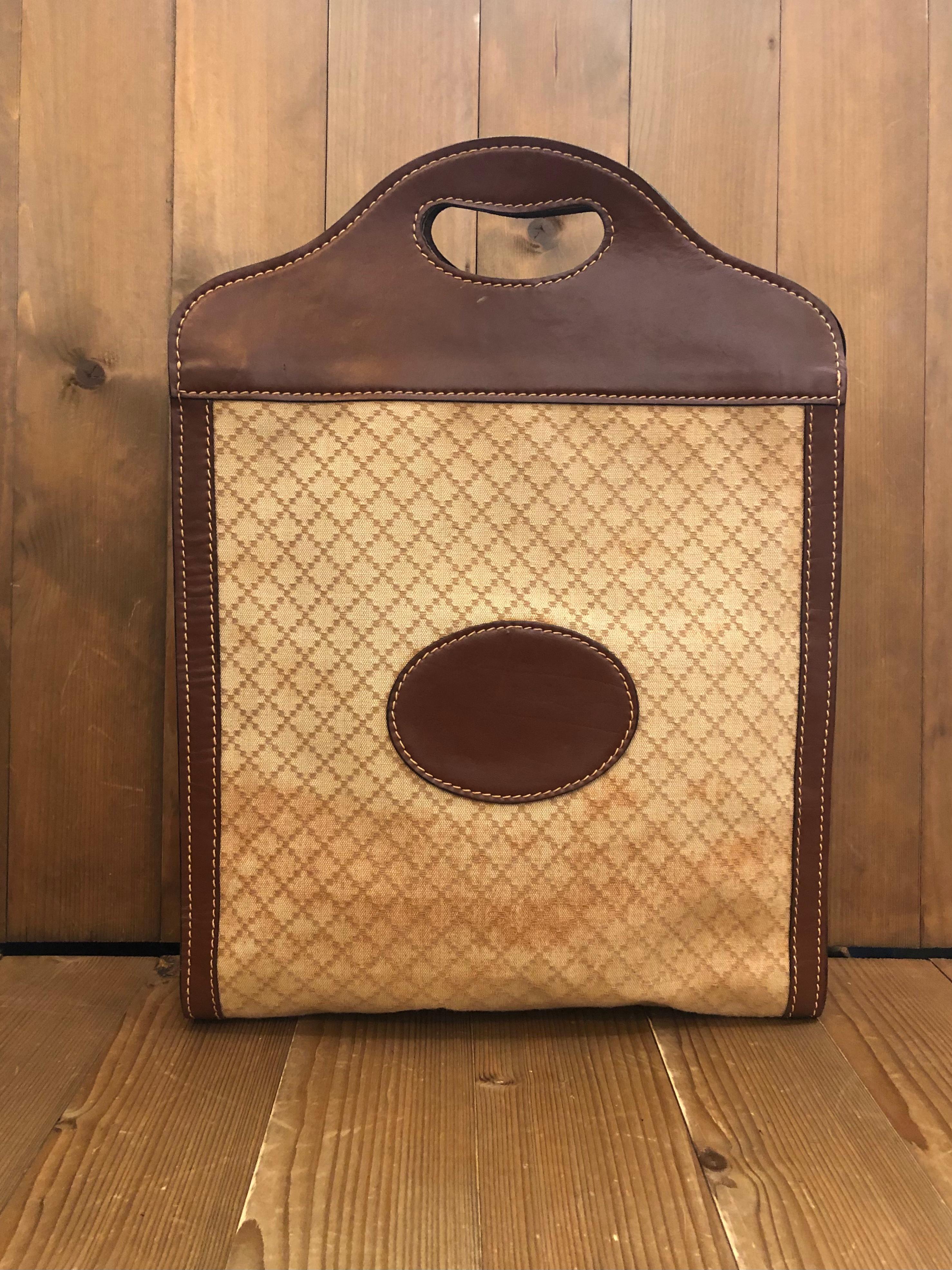 1970s Gucci book tote in Gucci iconic brown diamanté jacquard and leather. Made in Italy. Measures approximately 13.5 x 18 x 2.75 inches 

Condition -  Good vintage condition with wear  from long time storage

Outside: Creases and marks on leather
