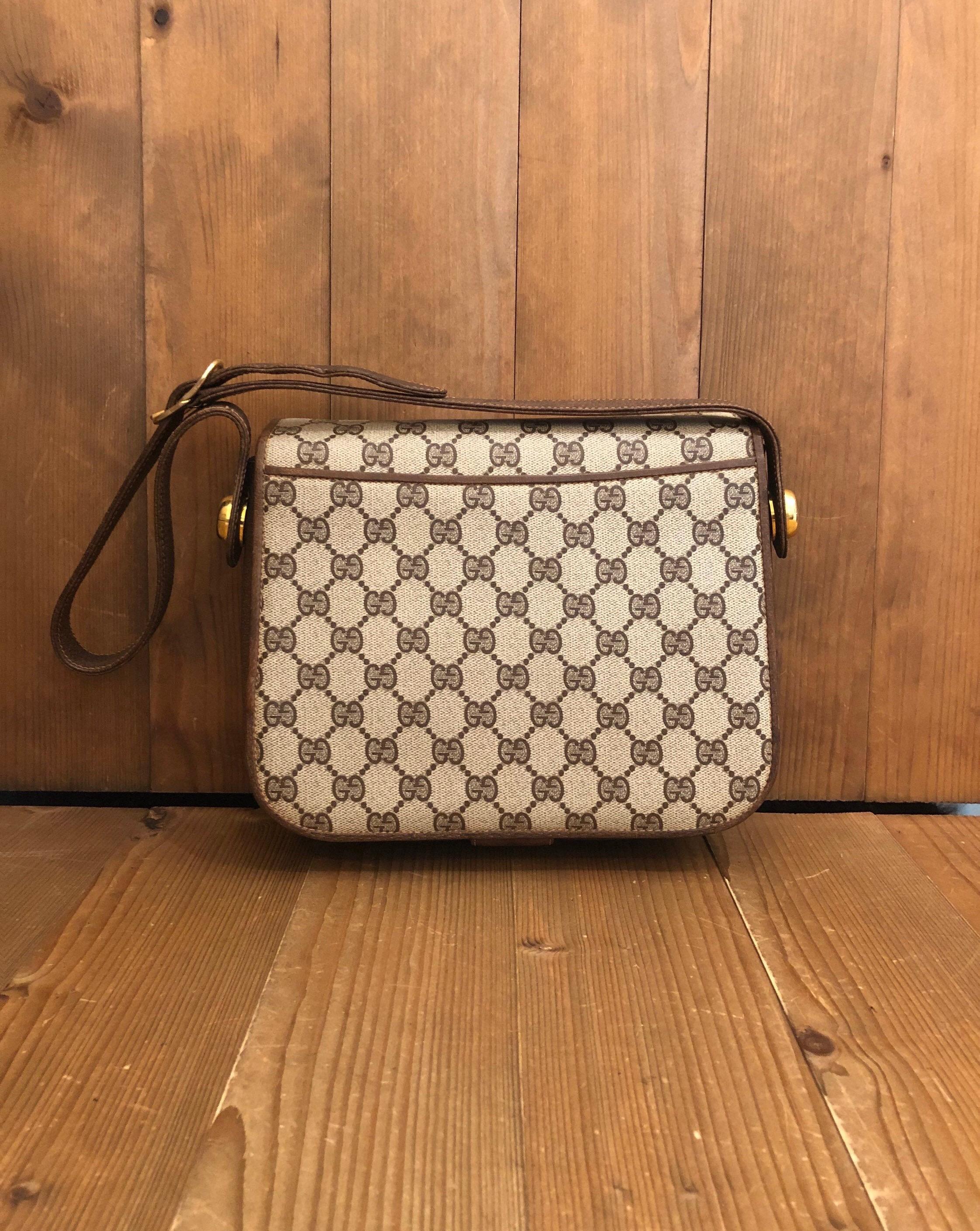 1970s Gucci Brown Monogram Canvas Shoulder Bag

Material: canvas/Leather
Origin: Italy
Measurements: 23.5 x 18.4 x 7.6cm Drop 28 cm (9.25 x 7.25 x 3 Drop 11 inches)
Specifications: 1 interior zip pocket/1 back open pocket 

Condition:
Rank BC Used