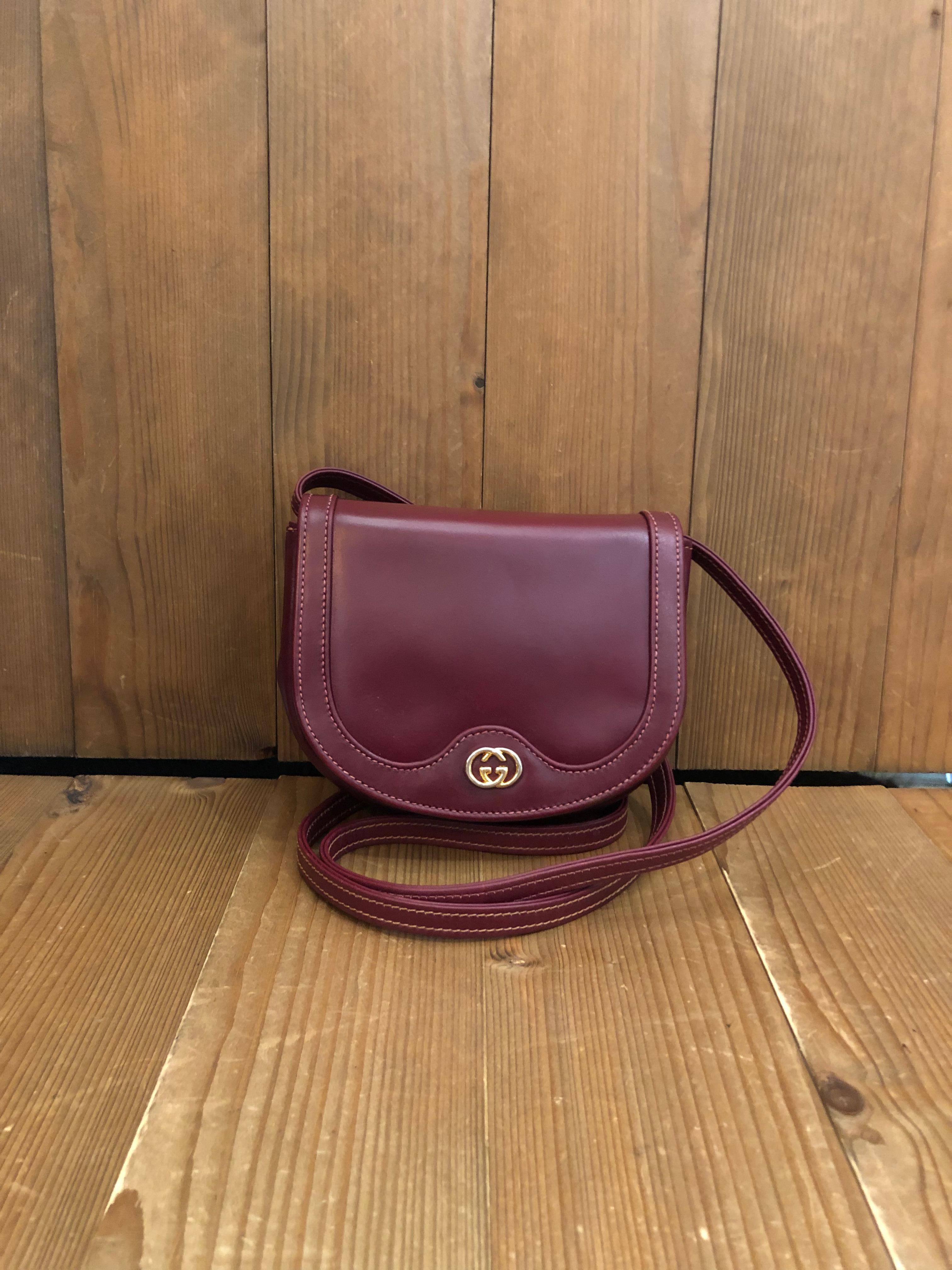 1970s GUCCI mini crossbody bag in burgundy leather. Made in Italy. Measures 6.5 x 5 x 1.25 inches Strap drop 22 inches. It’s mini in size yet fits plus-sized iPhone. Snap fastening closure. Comes with dustbag.

Condition - Minor signs of wear.
