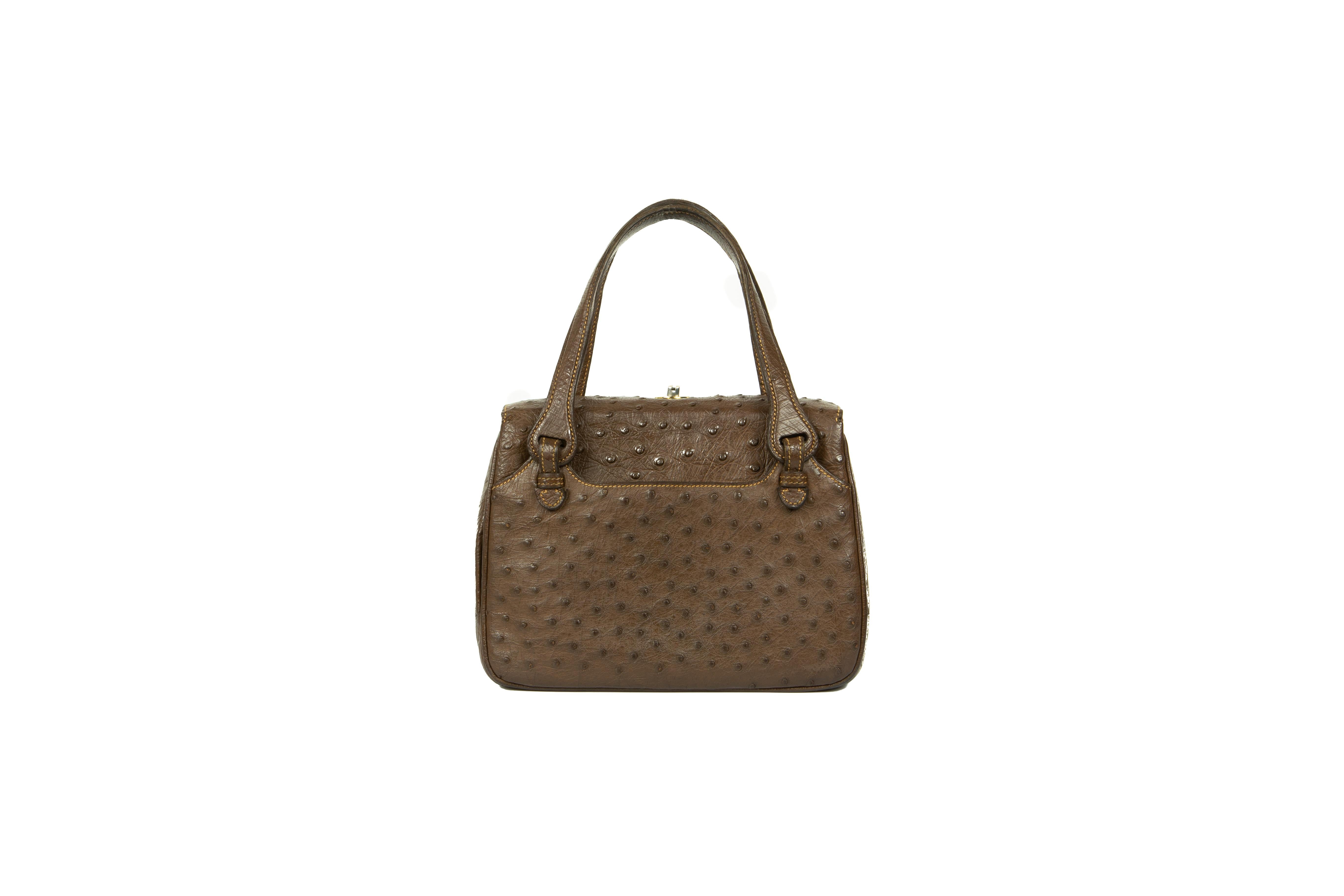A rare late 1970s Gucci chocolate-brown ostrich handbag with self-piping and ochre top-stitching throughout, comprising of three compartments, the central one with a gusseted zipper and two patch pockets, and two further outer pockets, fully lined