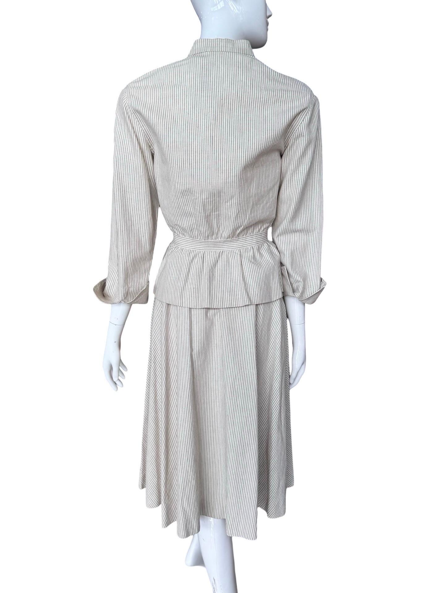 Stunning, classically chic piece from a 70s era Gucci collection and in near perfect condition.  This is a heavy linen cotton mix fabric in soft stripes.  Flared full skirt and the jacket is mandarin collar with buttons down the front, peplum bottom