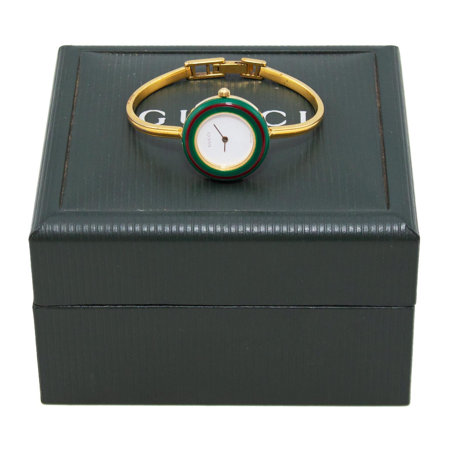 An accessory that goes with every outfit, this Gucci watch from the 1970's has 12 interchangeable colored bezels that screw on to the face. Choose from pastels, basics or the classic Gucci red and green stripe. The body of the watch is goldtone with
