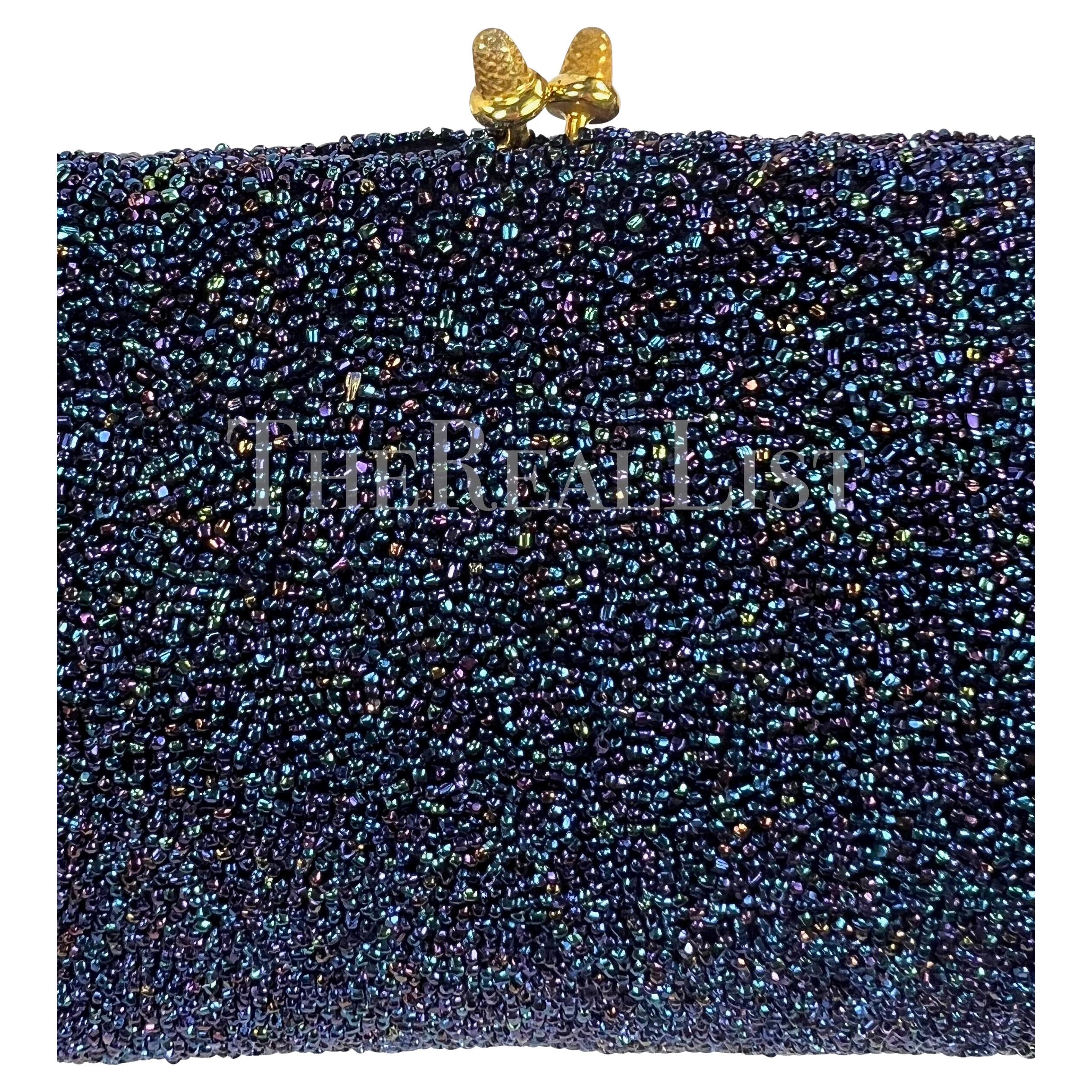 Presenting an incredible iridescent blue Gucci beaded clutch. Step back in time to the glamorous era of the 1970s with this stunning bag adorned in shimmering blue iridescent caviar beads. Its captivating design is tastefully complemented by the