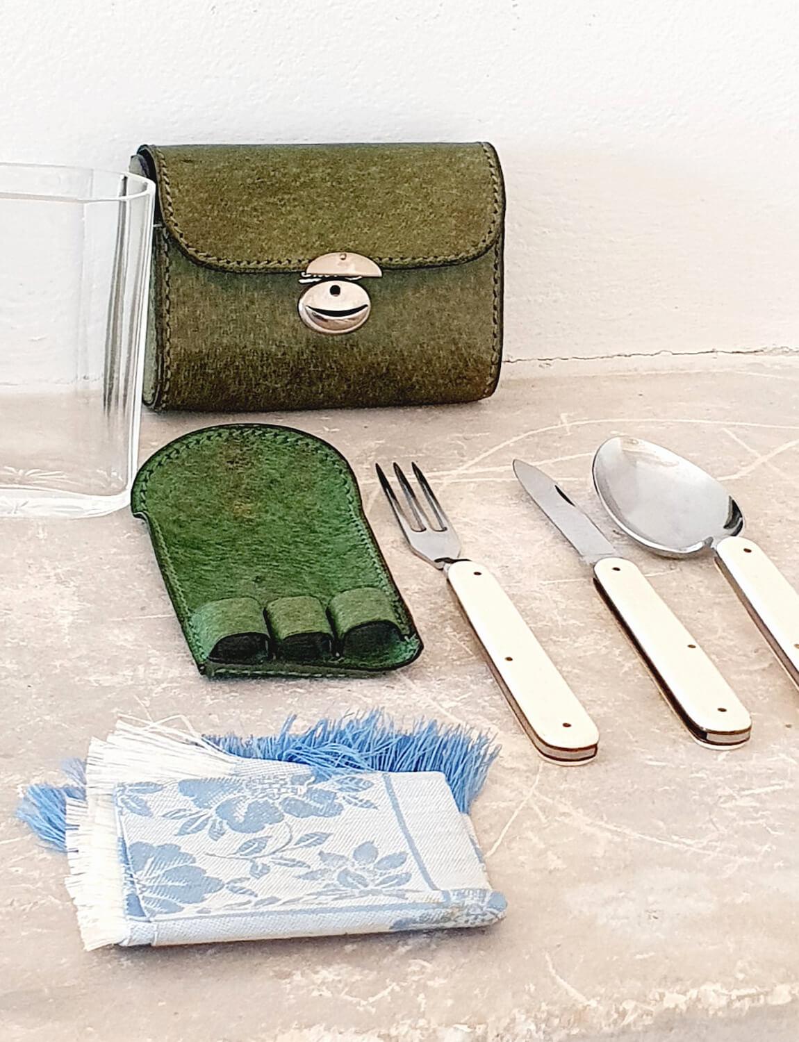 A very special original 1970s Gucci travel set containing folding knife, fork and spoon which neatly fit into a portable glass with napkin. The green leather case is stamped with Gucci and has a working silver clasp. It is so small it can fit into a