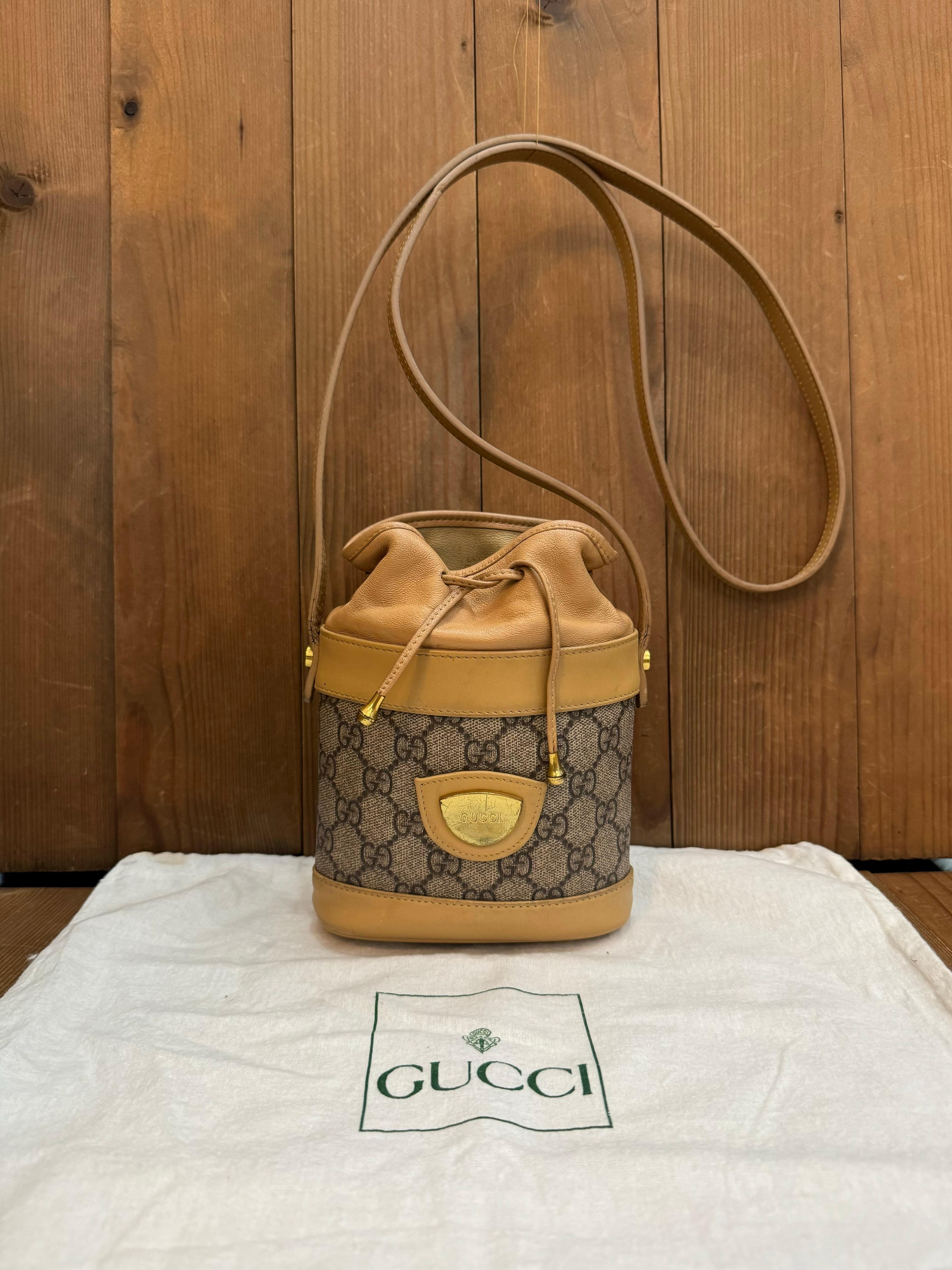 Ce mini sac à bandoulière à cordon de serrage vintage de Gucci est confectionné en toile enduite du monogramme GG en marron et en cuir de veau marron, avec des ferrures dorées. La fermeture par cordon sur le dessus ouvre sur un intérieur en cuir