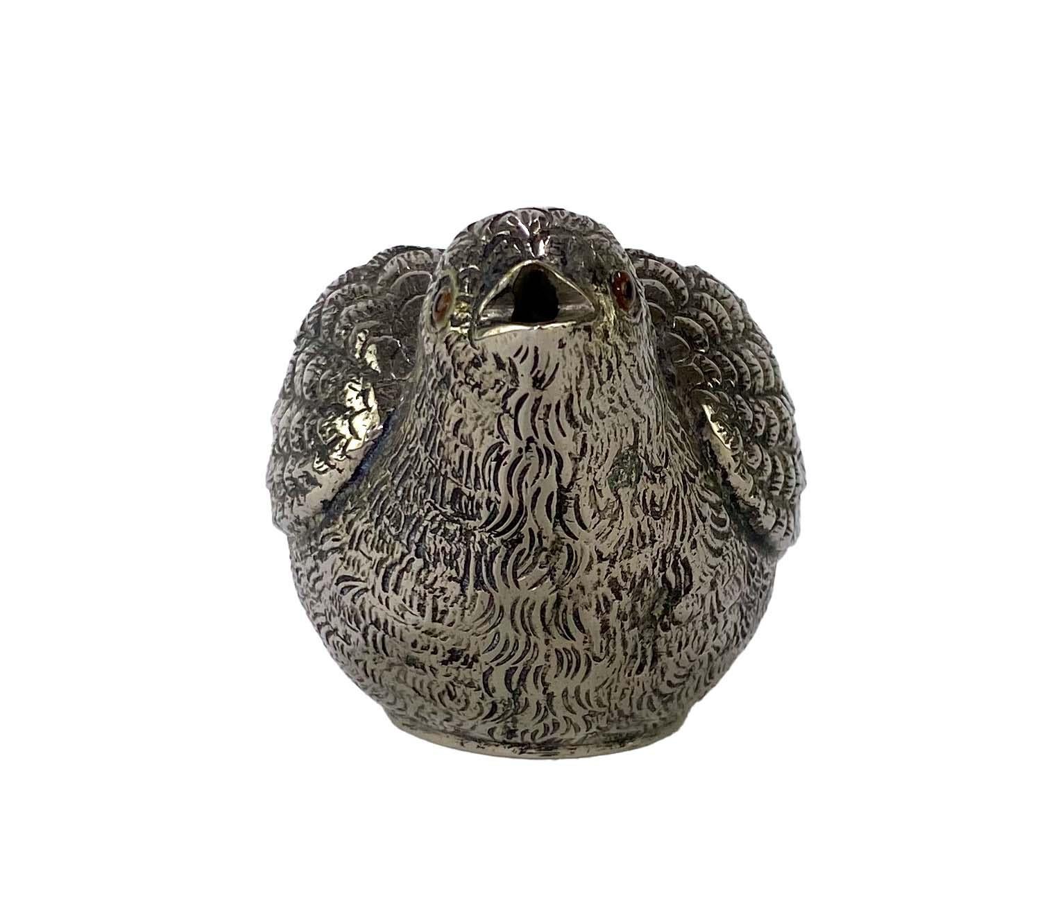 Presenting a miniature votive holder/trinket bowl made by Gucci in the 1970s. In the form of a small sparrow, this piece is made of heavy silver-toned metal and features embellished eyes. This makes a wonderfully unique gift! Check out our page to