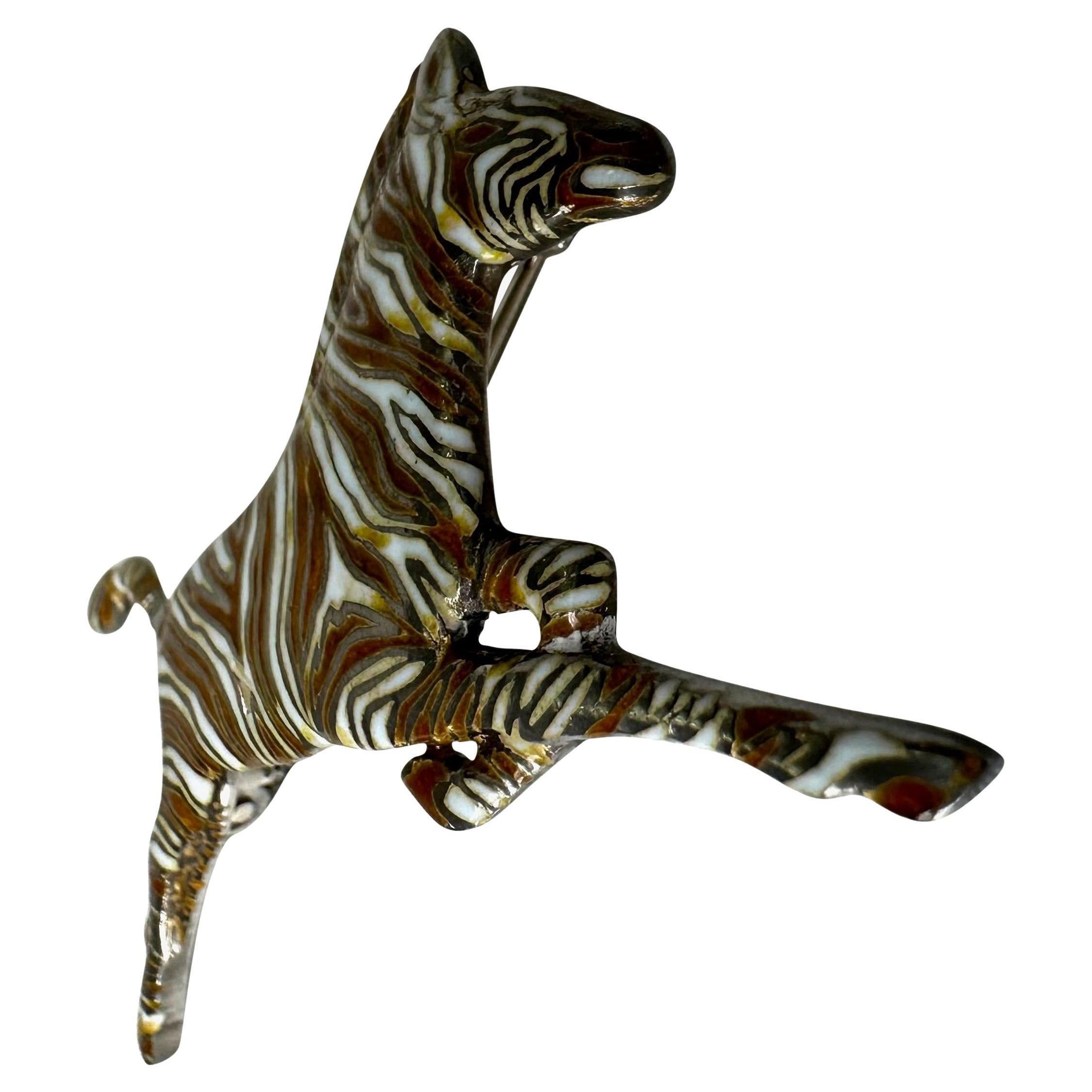 Presenting a sterling silver enamel-covered Gucci Zebra brooch. From the 1970s, this zebra was used in many Gucci pieces and patterns. A rare piece from the early days of Gucci, this brooch is the perfect addition to any Gucci lover's