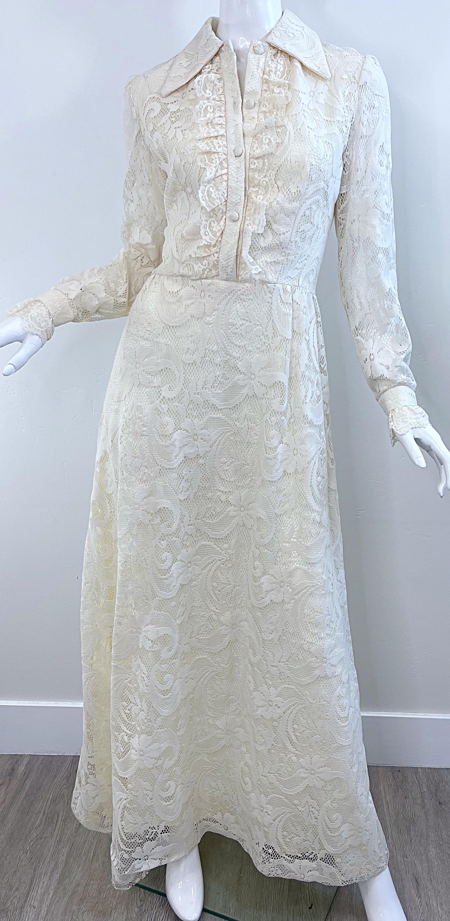 Pretty 1970s Gucci style ivory lace long sleeve maxi dress ! Features tuxedo ruffles down the front bodice. Flowers printed on the lace. Fabric covered buttons up the front, an hidden metal zipper up the back with hook-and-ey closure. 
In great