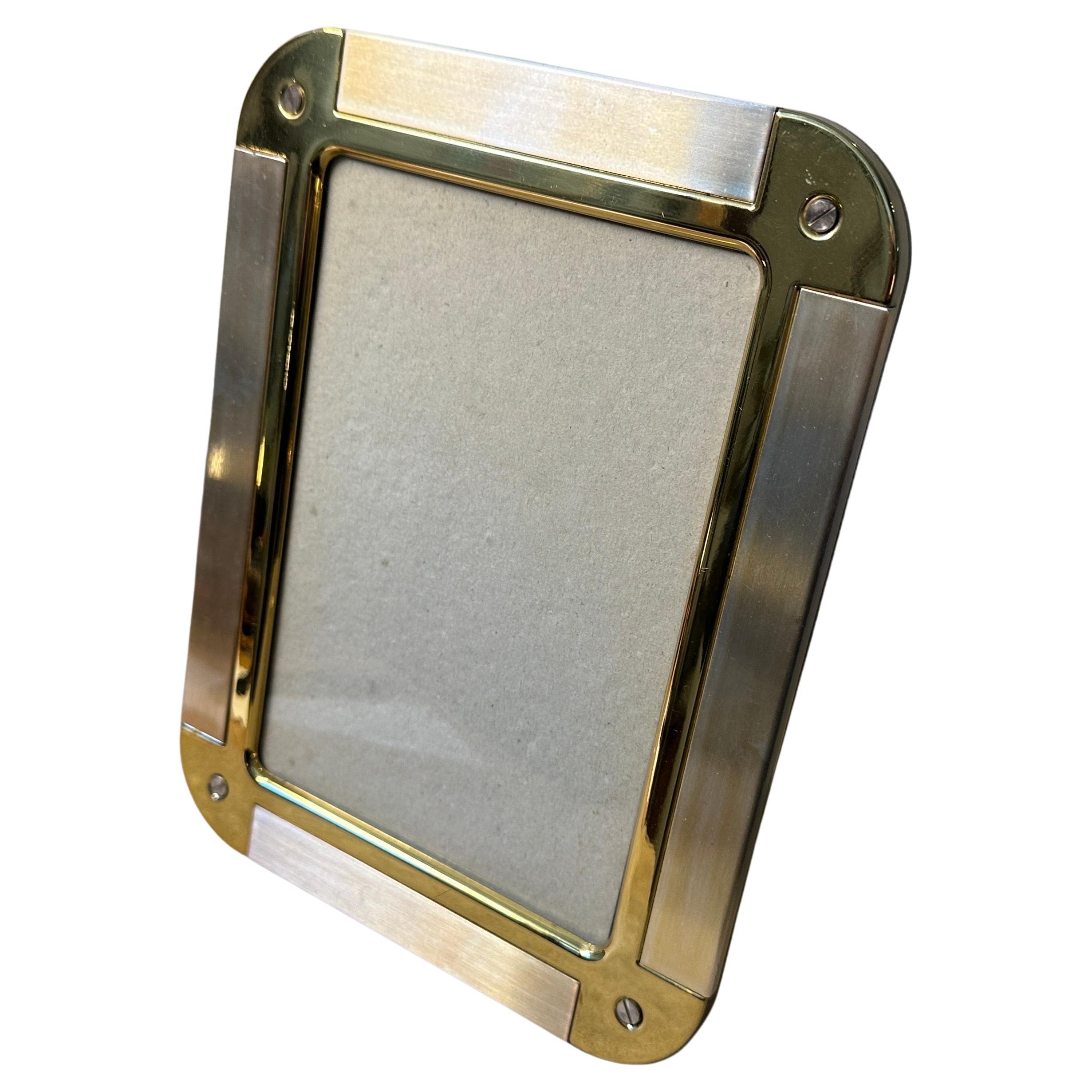 This picture frameis an exquisite piece of home decor, reflecting the luxury, sophistication, and innovative design that Gucci and similar high-end Italian brands are known for. Crafted from metal, the frame features a combination of silvered and