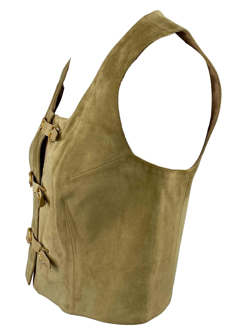 TheRealList presents: A Gucci suede vest with signature equestrian details. This piece is lined in Gucci logo fabric and features gold-toned horseshoe buckle closures at the front. The soft suede is cut in a tapered fit that allows this to be worn