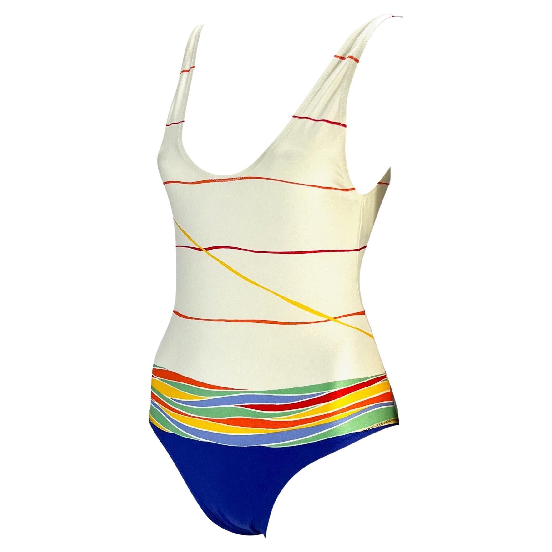 Presenting a gorgeous 1970s Gucci bathing suit with matching cover up shawl. The one piece bathing suit and pareo feature a colorful abstract print on off-white. In amazing condition, you would never guess this fabulous set is nearly 50 years old.