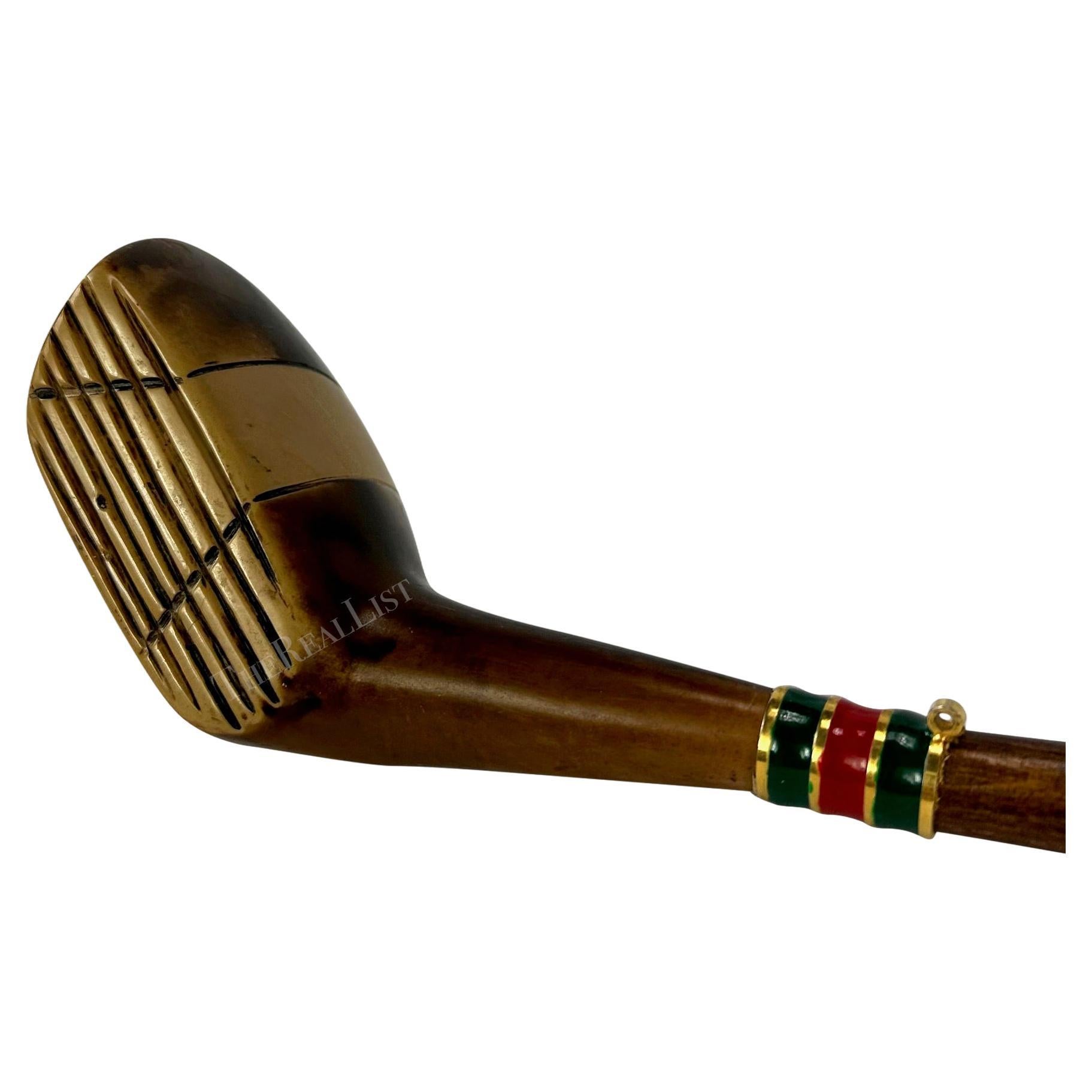 Presenting a wooden golf club Gucci shoe horn. From the 1970s, this wooden shoe horn features a golf club head on one end and a horn shoe horn on the other end. This rare Gucci shoe horn is the perfect gift for the golf lover who has everything!