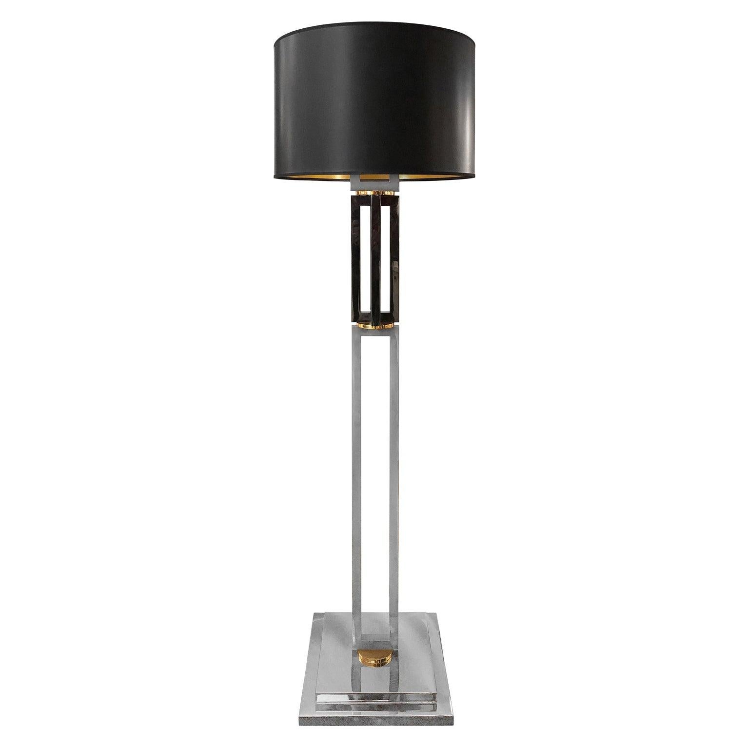 Gunmetal and chrome double column floor lamp with brass detail and original black drum shade, USA, 1970s.
        