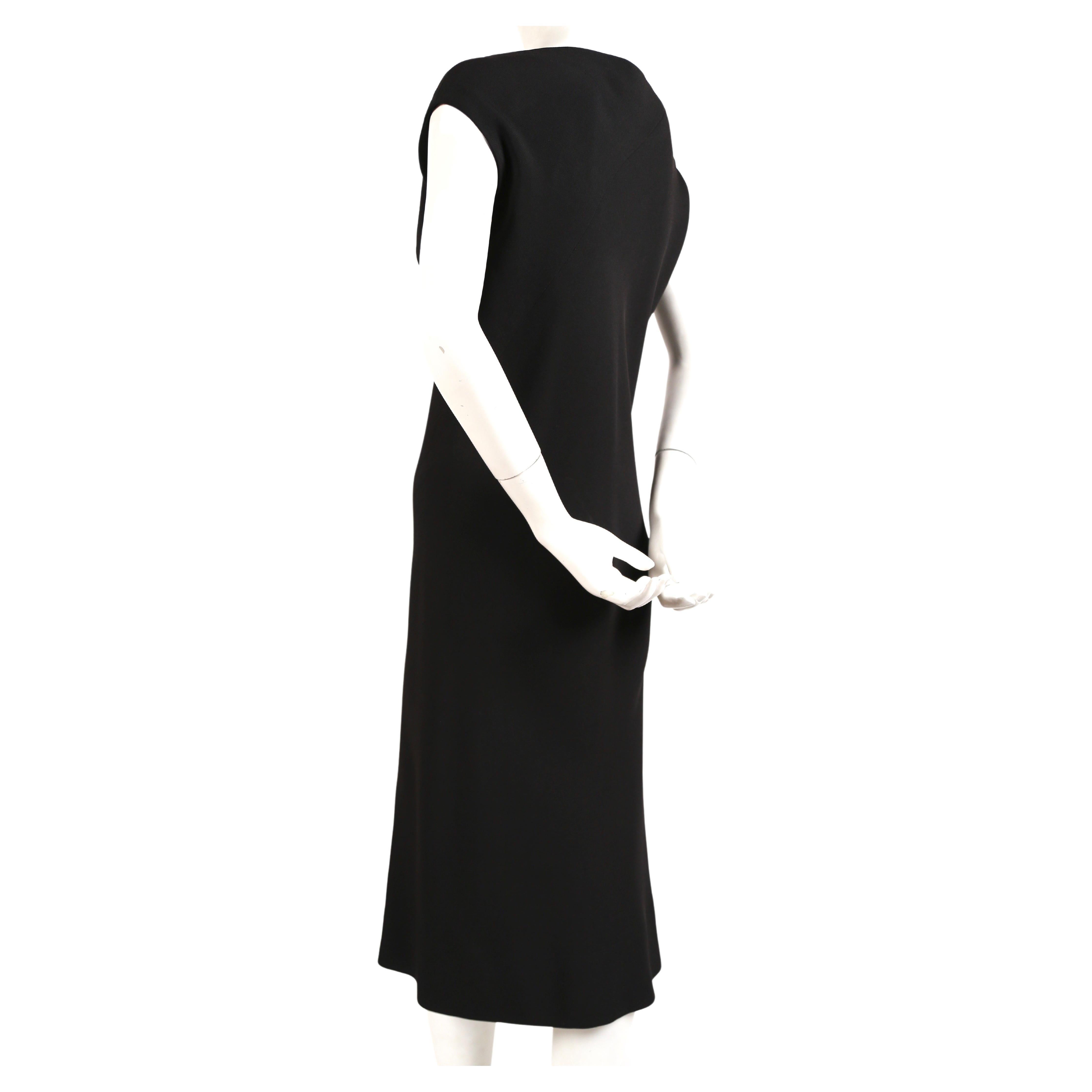 Jet-black, bias-cut dress with high center front slit from Halston dating to the late 1970's.  Best fits a US 4-6. Approximate measurements are 34