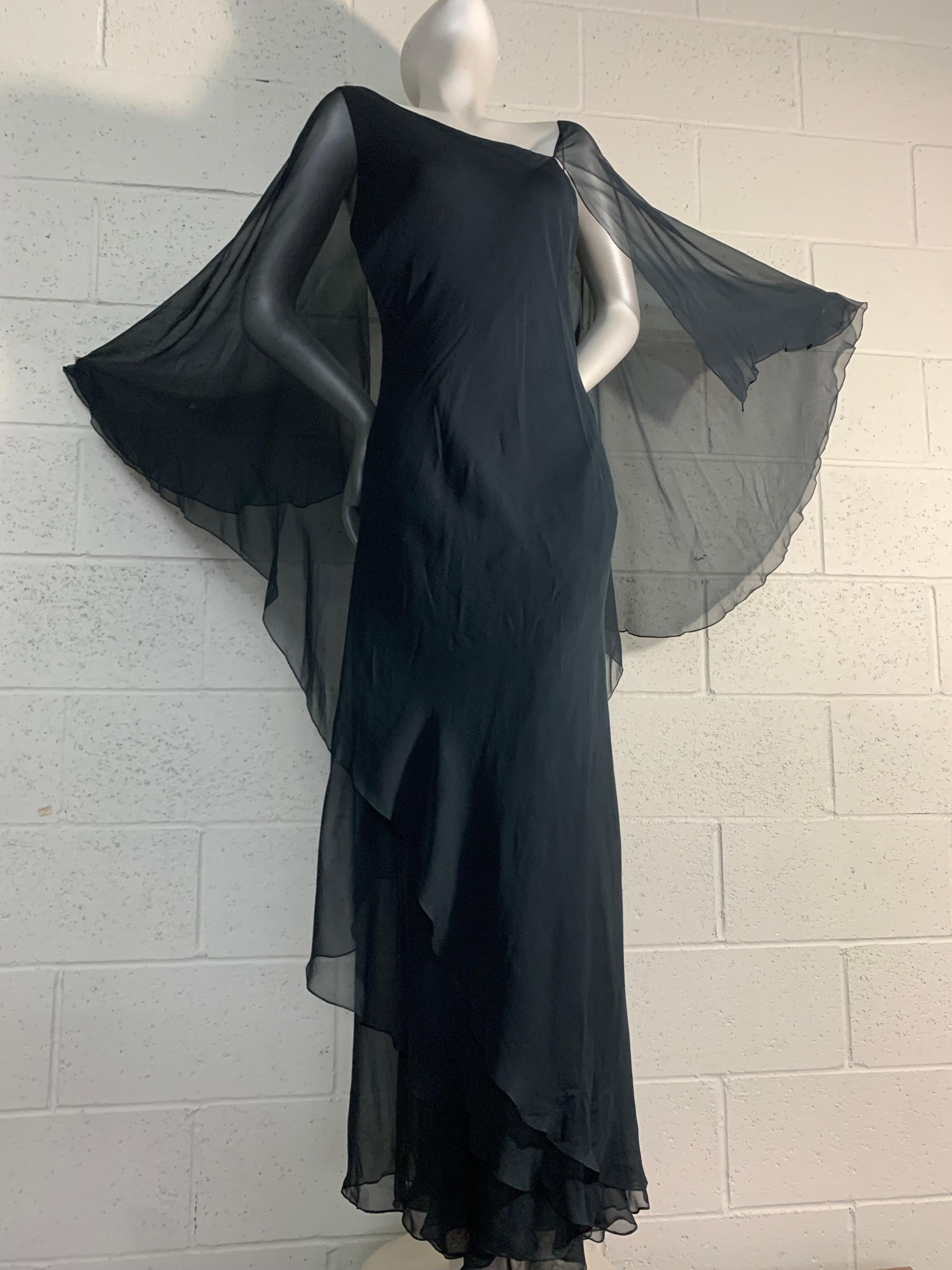 1970s Halston Black Silk Chiffon Tiered Bias One-Shoulder Gown with Attachd Sheer Cape: A stunning and sensual 7 layer swirl of bias cut silk chiffon with an attached sheer cape from a master of draping designs. US size 6-8. 