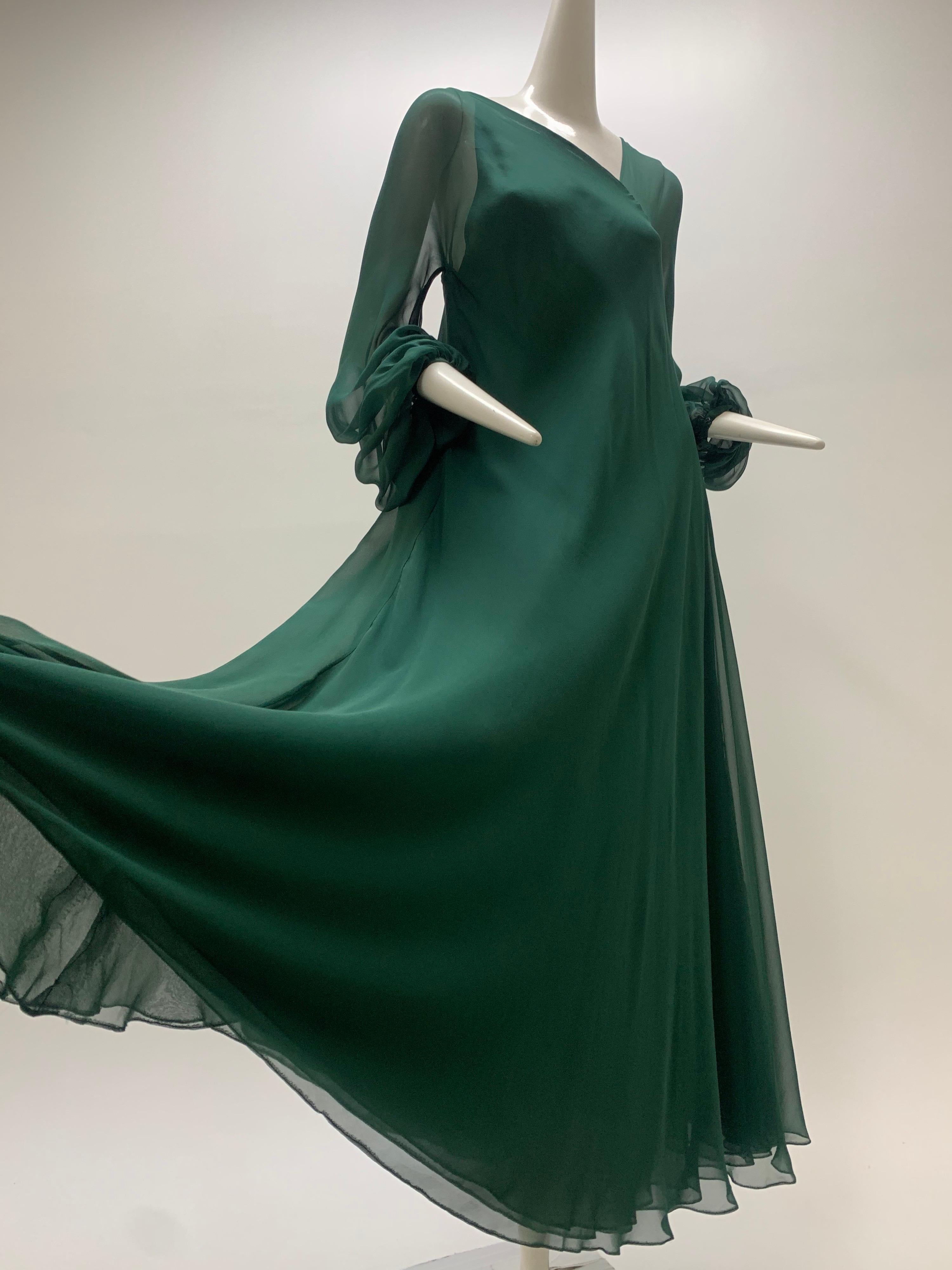1970s Halston Forest Green Silk Chiffon Asymmetrical Maxi. One shoulder is sheer chiffon and the other shoulder is constructed of layered bias cut chiffon. Balloon sleeves. Slips over the head, no closure. An early example of an iconic designer's