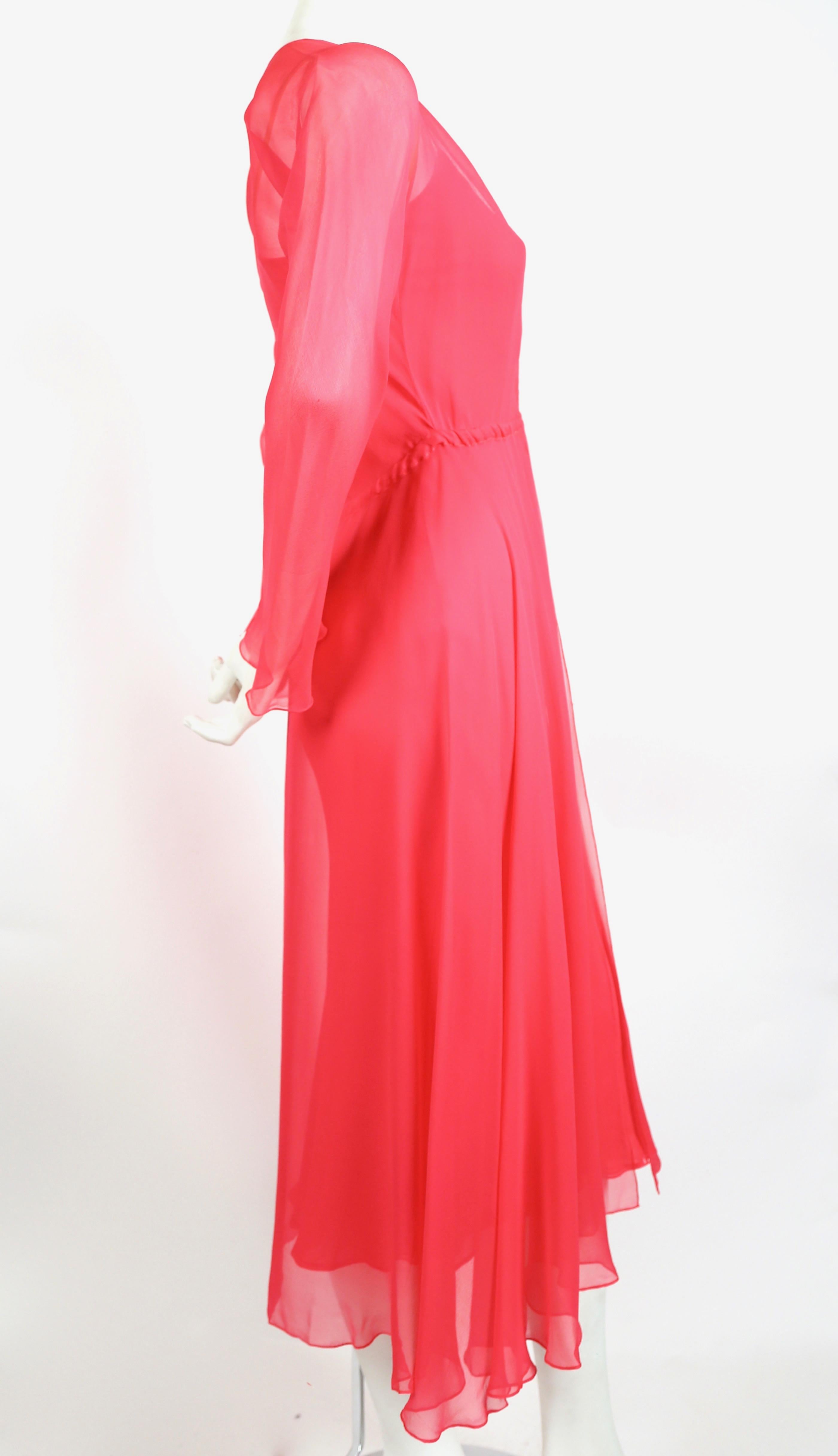 Vivid, fuchsia silk mousseline bias cut dress with long sleeve layer with gathered waist from Halston dating to the 1970's. Best fits a US 2 or 4. Approximate measurements: waist (unstretched) 26