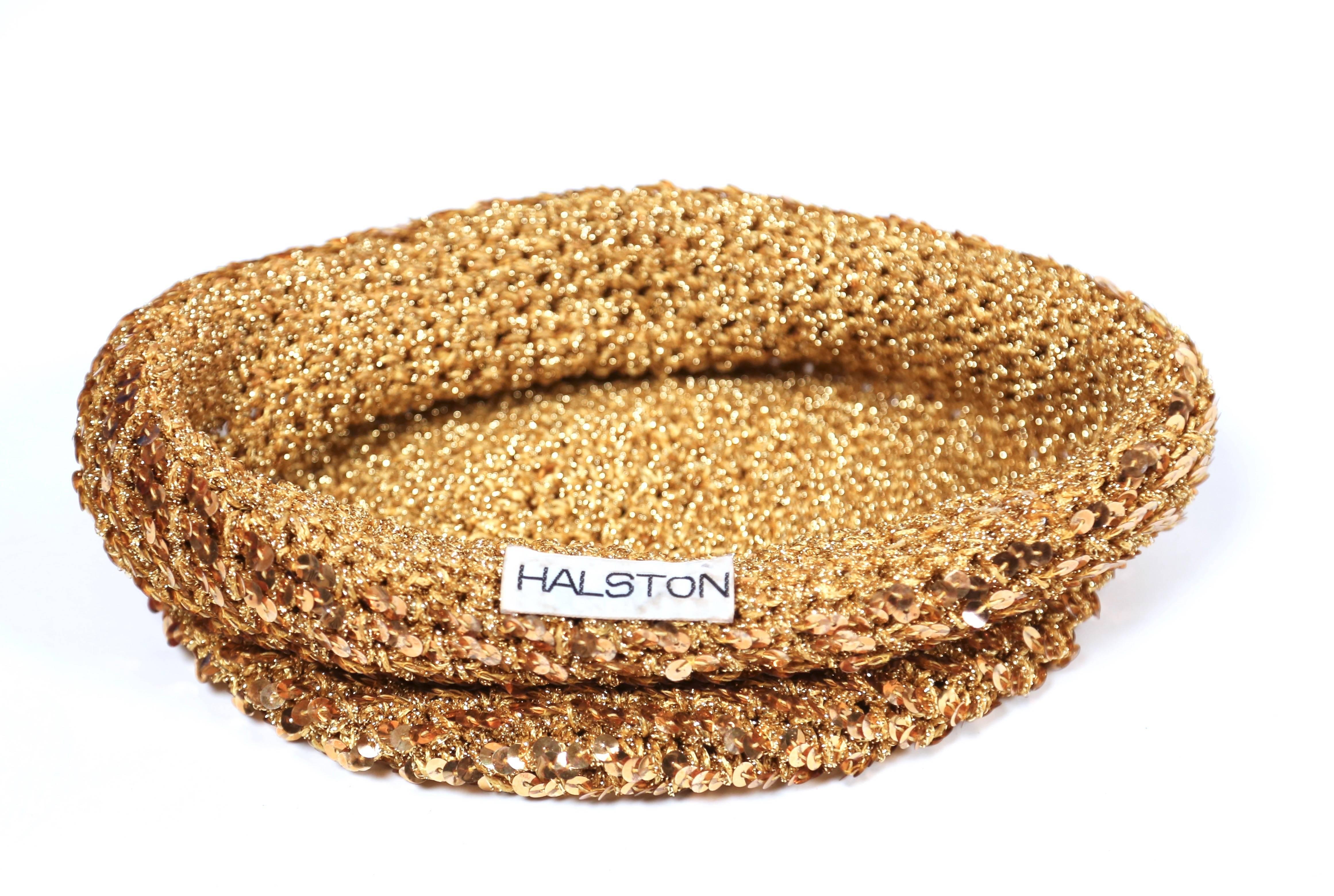 Gold knit skull hat with sequins and rolled brim designed by Halston dating the 1970's. Fits a small or medium head. Approximate circumference is 20.5