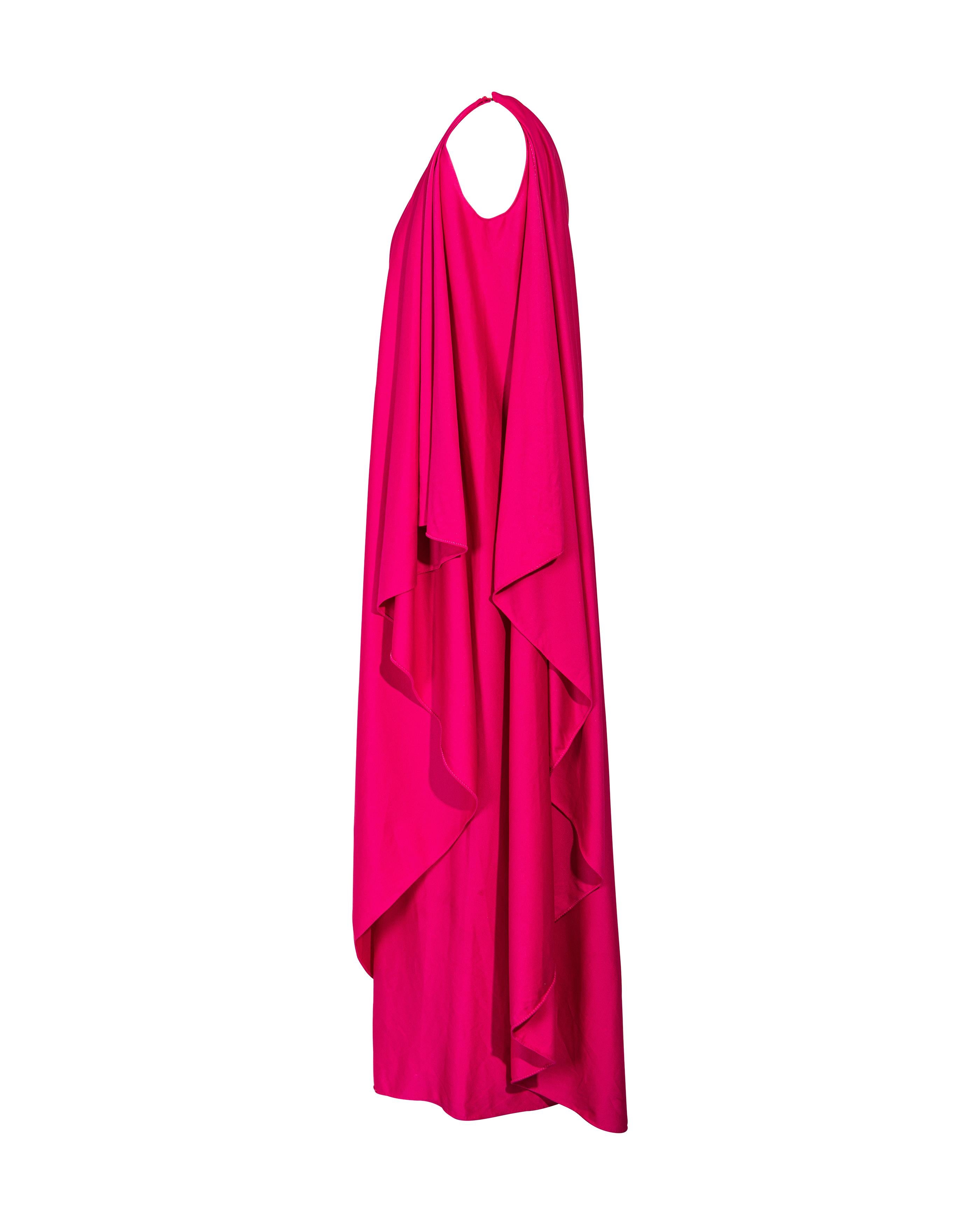 1970's Halston IV pink one-shoulder drape gown. Features layered fabric at sides. Hook closure at shoulder. In very good vintage condition with light wear throughout.