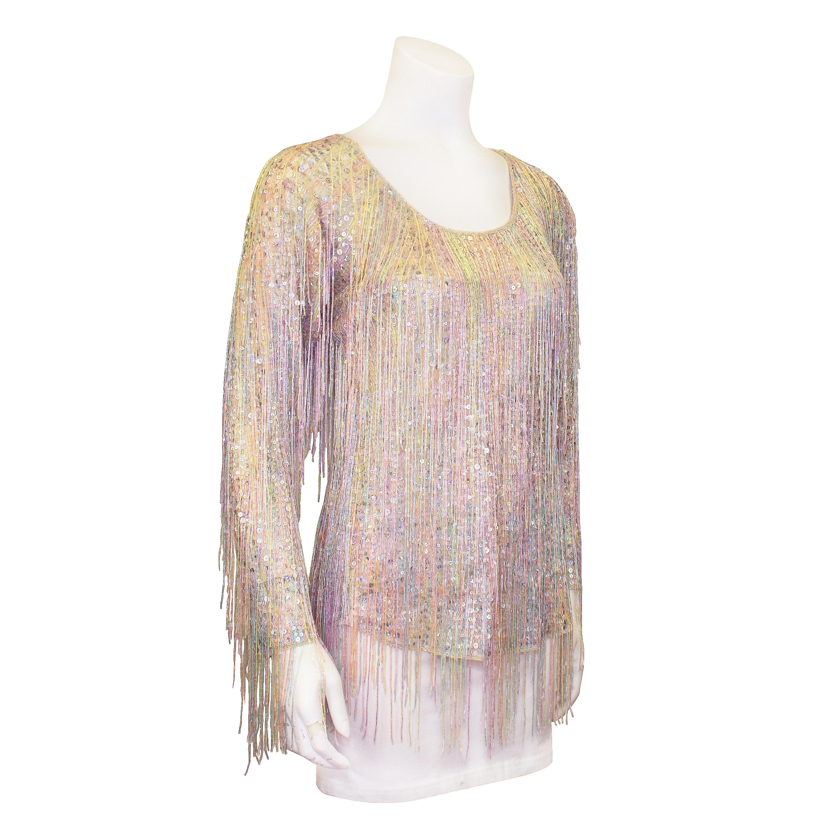 Hello Studio 54! This 1970s Halston piece is a work of art and could not be more fabulous. Long sleeved with a scoop neck, this top is entirely hand embellished with small silver sequins and rows of small iridescent pastel tube beads. Pastel blue,