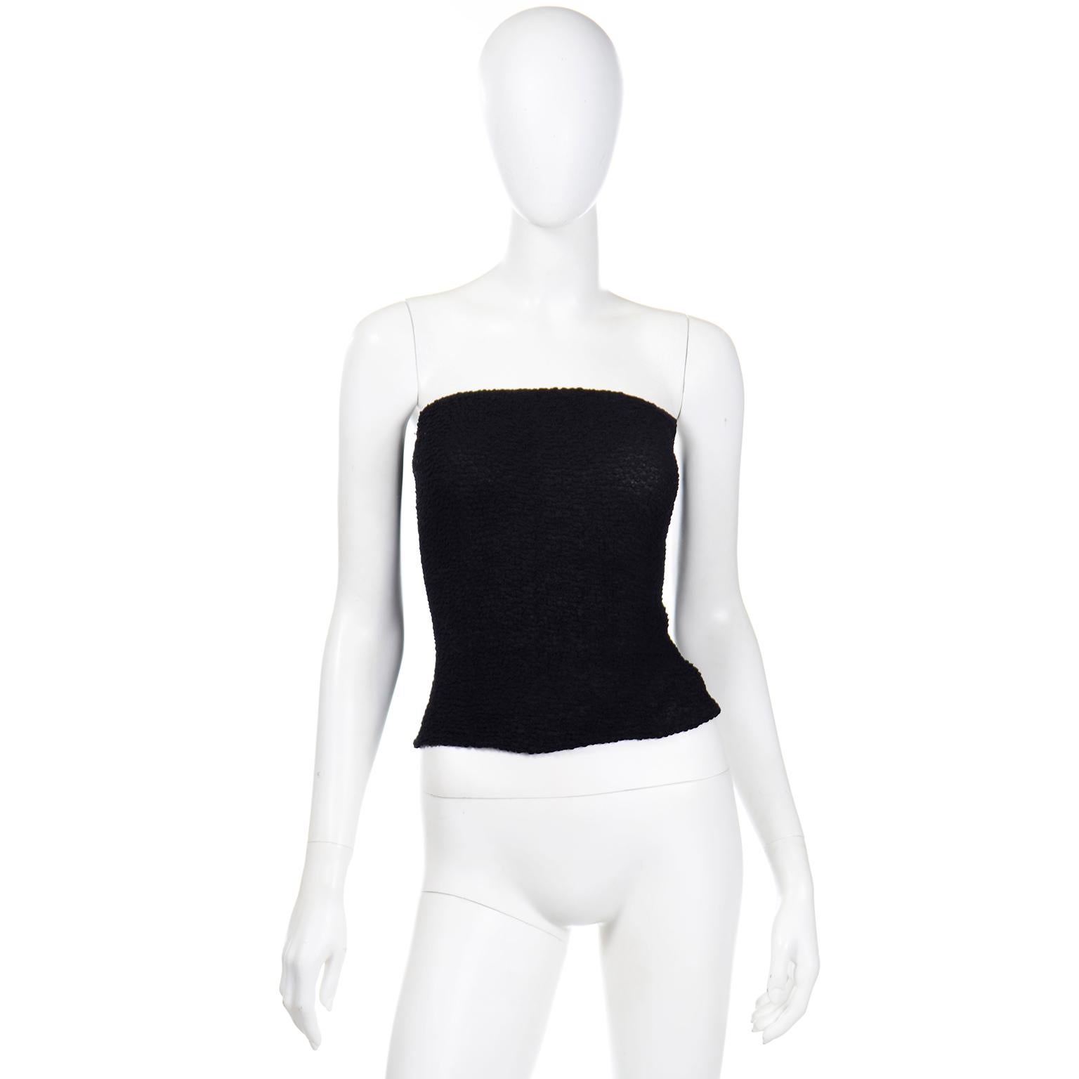 This is a 1970's vintage Halston black puckered elastic tube top. It has really unique elastic veins along the inside of the fabric that create a unique puckered effect on the reversed side. The top of the tube top has a thick elastic band to secure