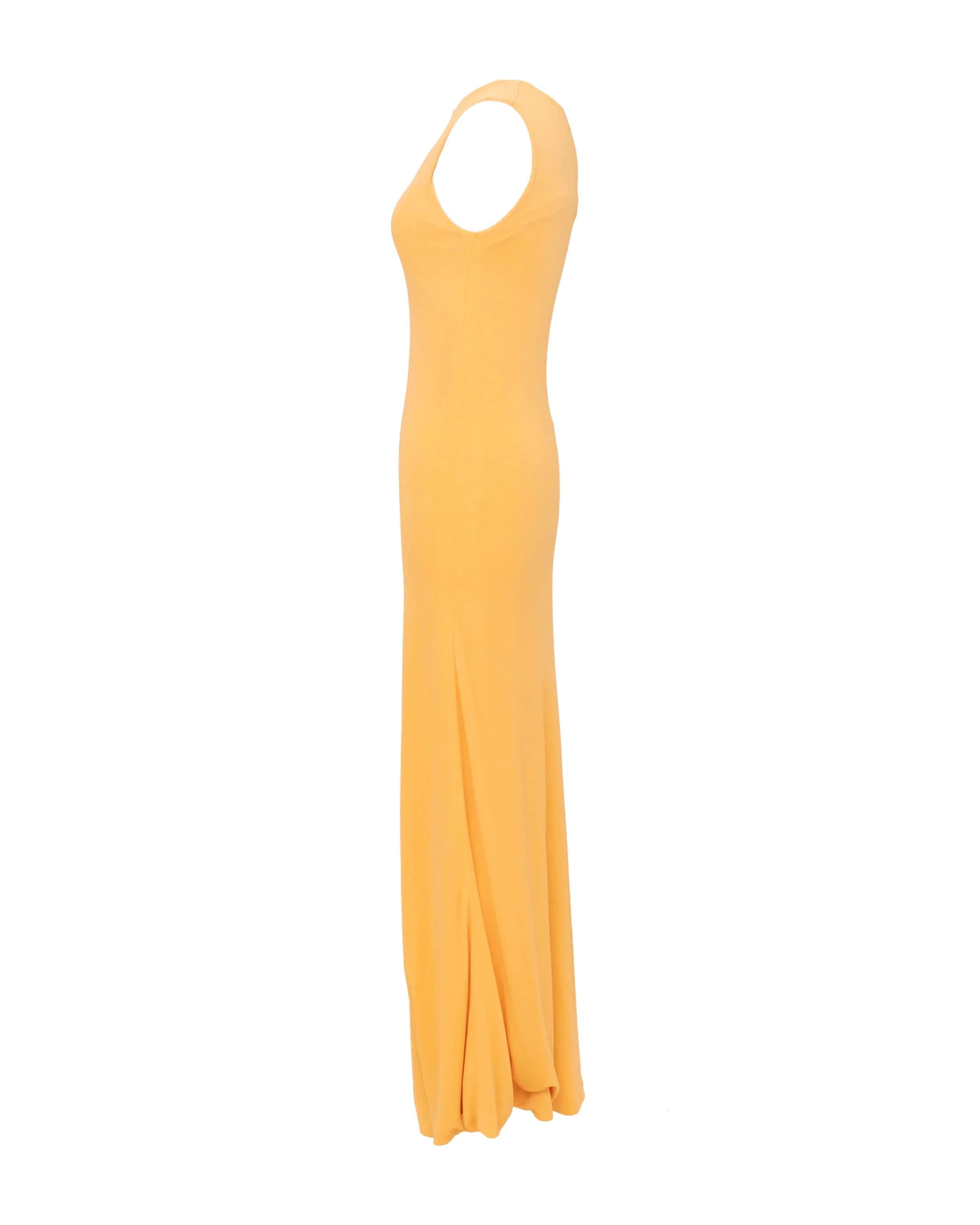 Bold yellow-orange 1970's Halston gown with keyhole chest opening. Full length sleeveless gown that hugs the body.
