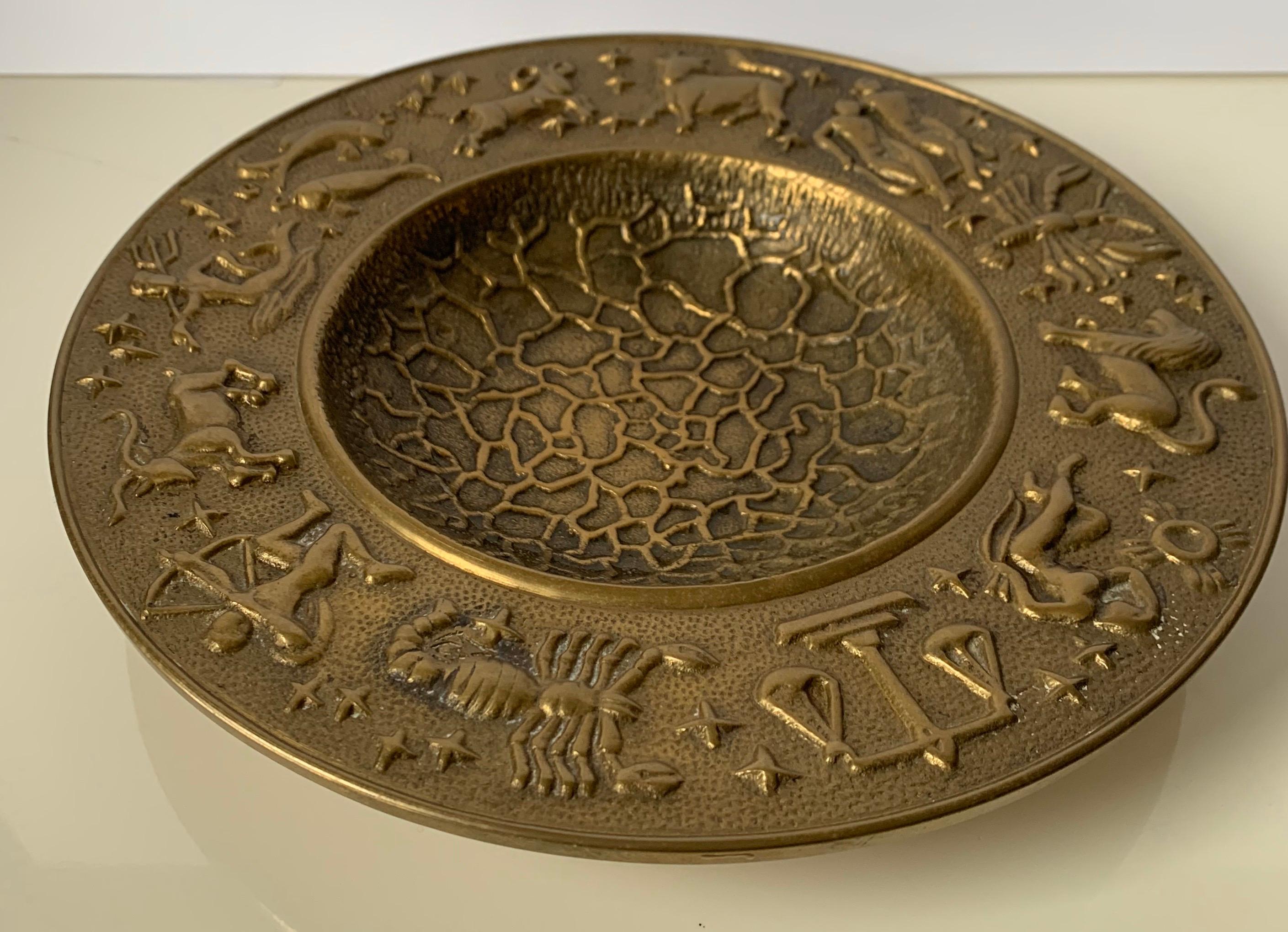 1970s hammered brass zodiac motif bowl. Solid brass with all over hammered detailing and circular zodiac motif. No makers mark.