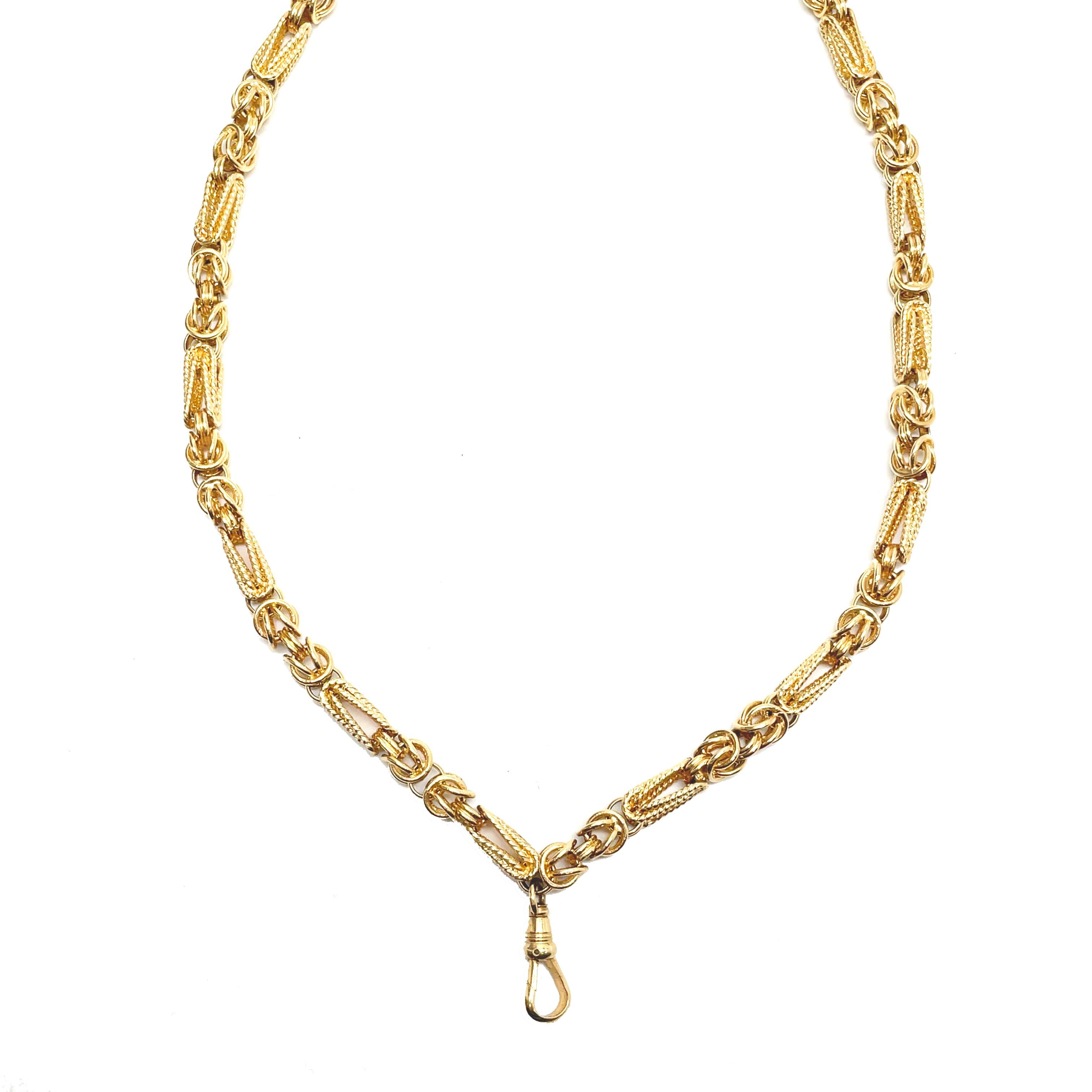 This is an exquisite hand-crafted chain composed of 14K yellow gold that dates back to the 1970s! This gorgeous chain was crafted by hand and features a gorgeous twisted and interlocking metal design which creates a unique texture to the chain. The