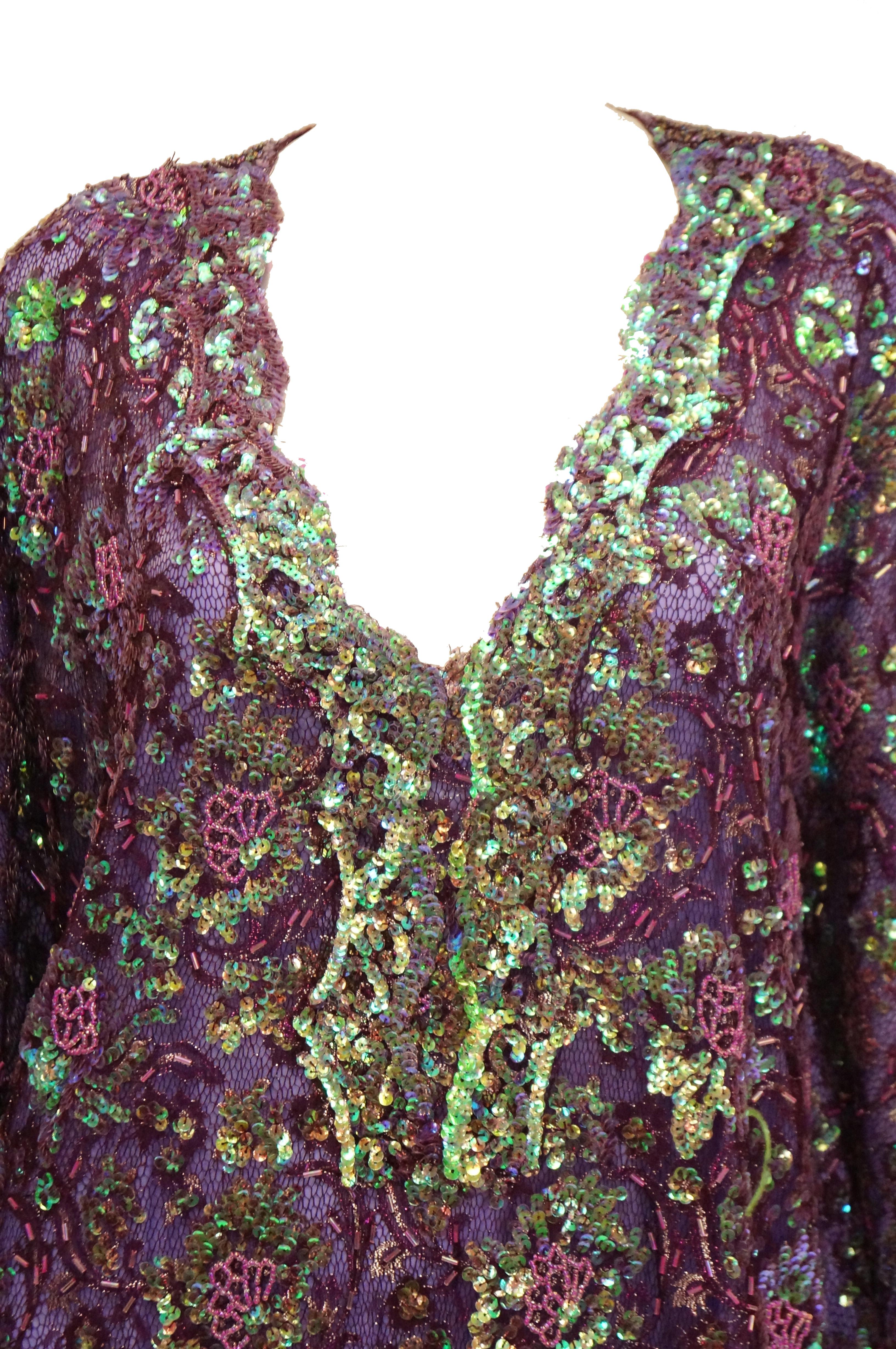 Amazing and bold iridescent purple - green shift kaftan! This maxi length garment features the typical airy cut of the kaftan, with a loose silhouette, three - quarter kimono sleeves with long armholes, and a V - neckline. The dress is primarily
