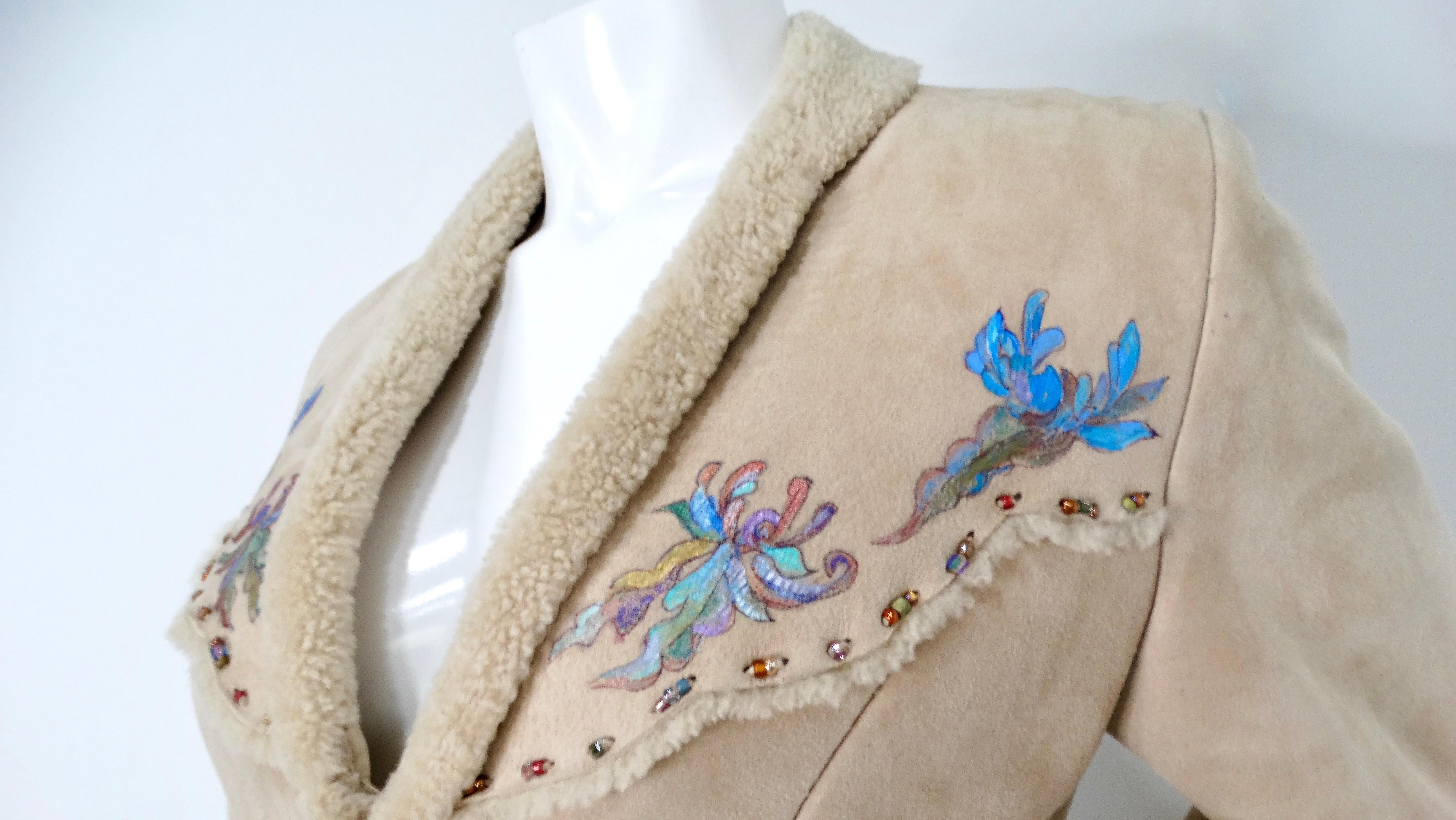 The 1970s Hand-Painted Floral Beige Suede Jacket is a stunning vintage piece that embodies the era's artistic spirit. This zip-up jacket features exquisite hand-painted floral motifs, adding a unique touch to its soft beige suede base. The luxurious