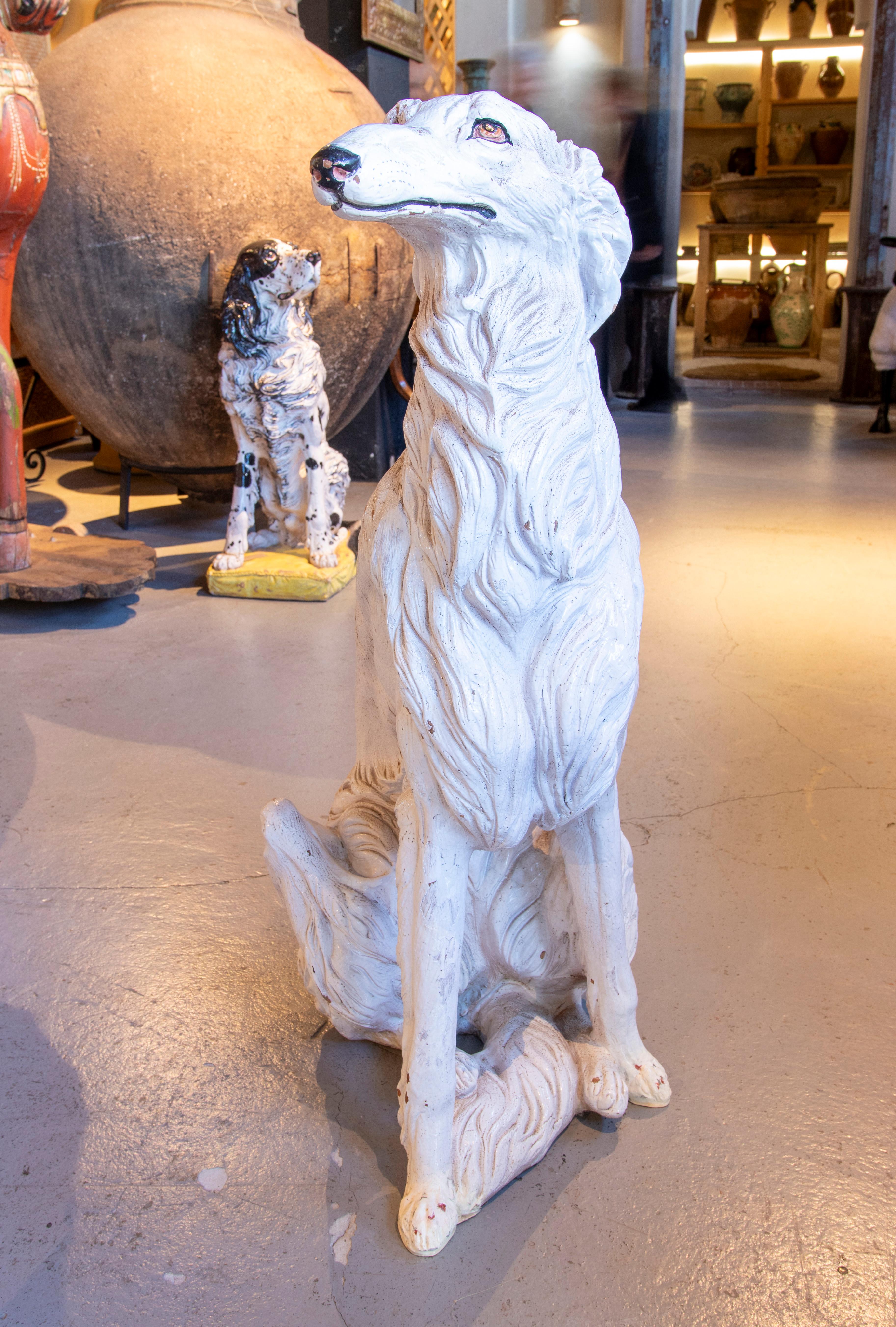 Diese Keramikskulptur stellt einen russischen Borzoi-Windhund dar, eine Hunderasse, die für ihre schlanke, elegante Silhouette bekannt ist. Das aus glasierter und handbemalter Keramik gefertigte Stück besticht durch sein detailliertes Fell mit