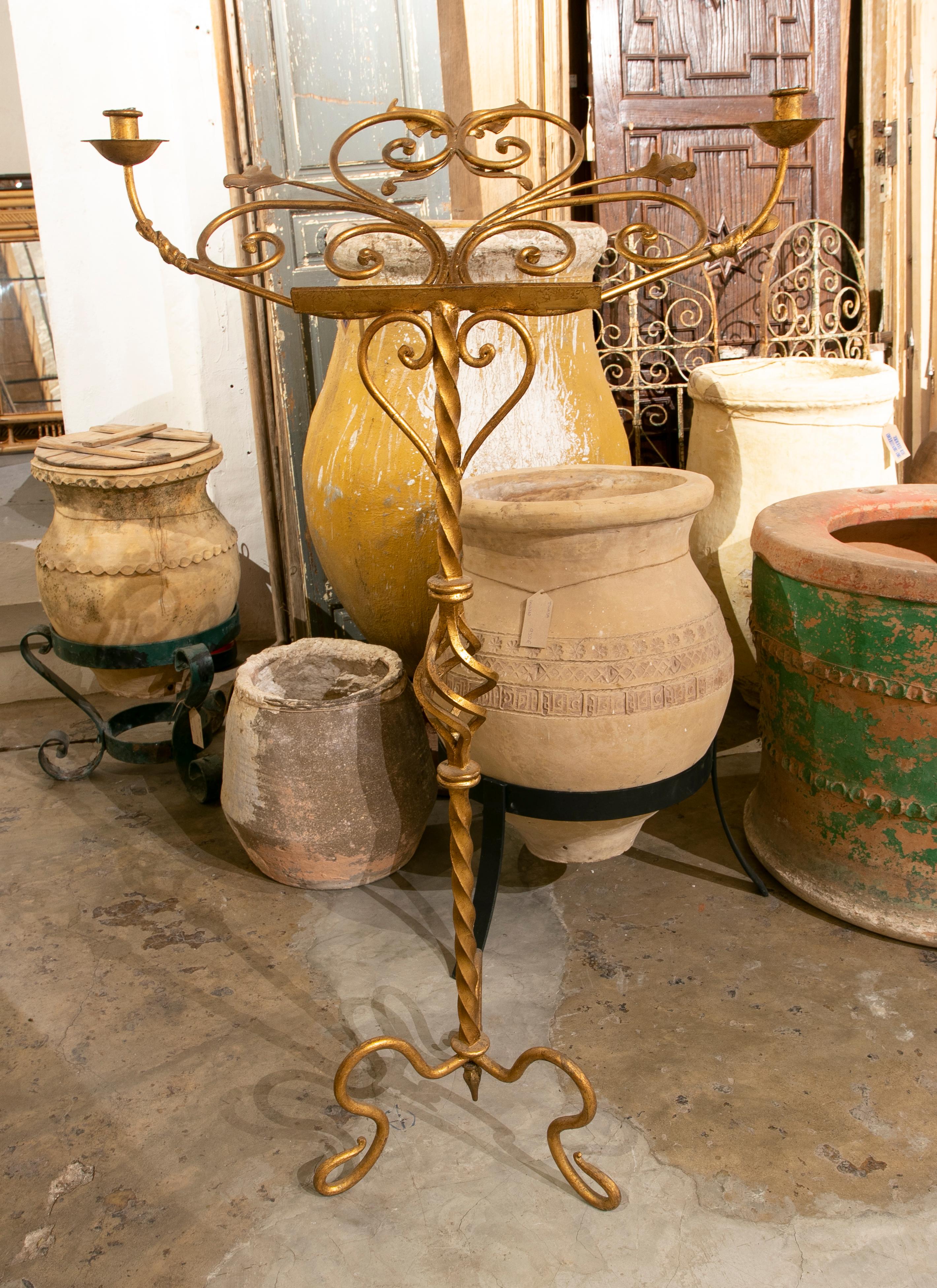1970s handmade standing gilded iron candlestick.