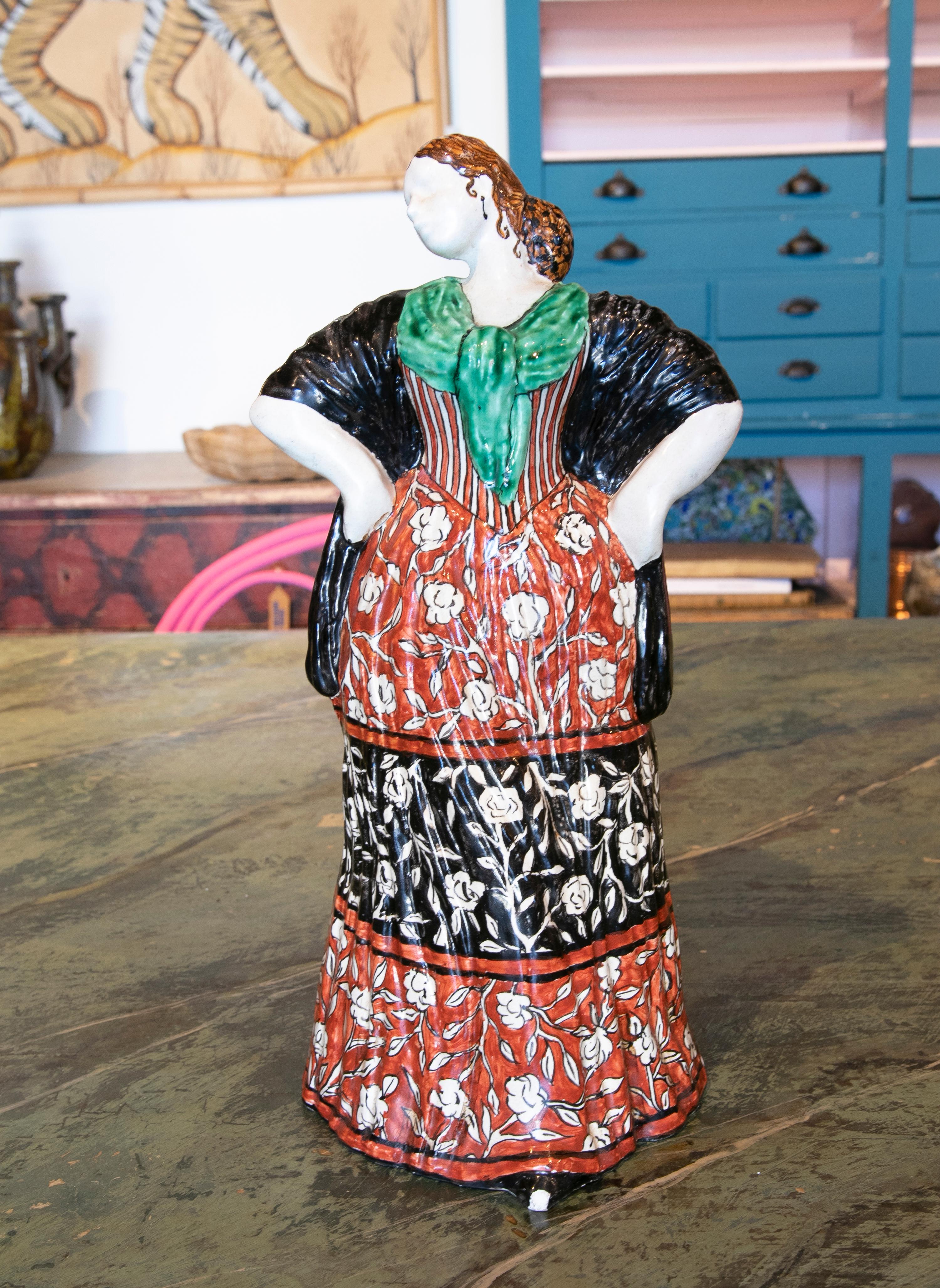 1970s handpainted glazed ceramic sculpture of a woman in typical Spanish clothing.