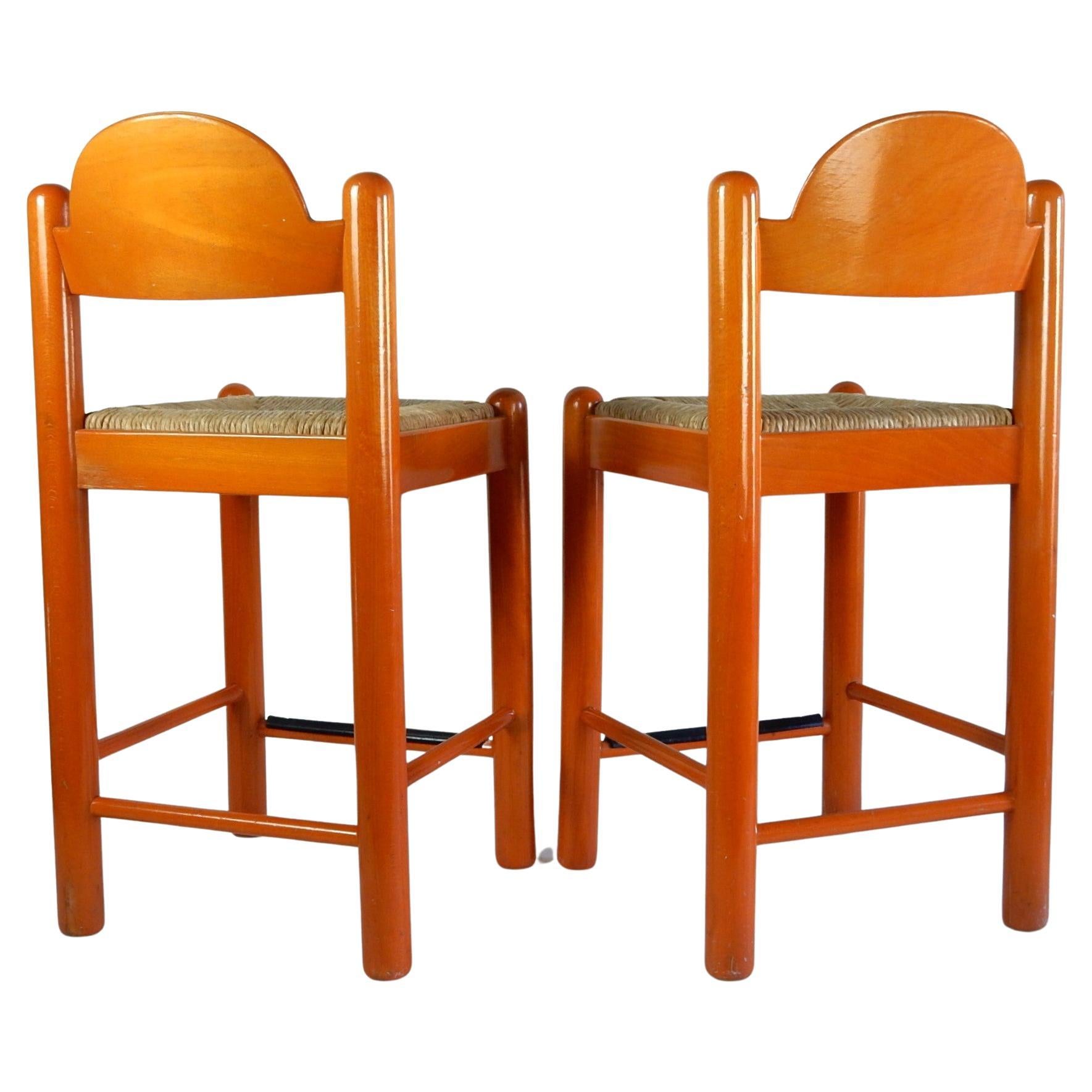 Pair of circa 1970's orange dyed Birchwood bar stools designed by Hank Lowenstein.
Hand woven rush seating. Heavy well crafted stools.
Both are solid showing signs of use but not abuse.
Clean and ready for placement.