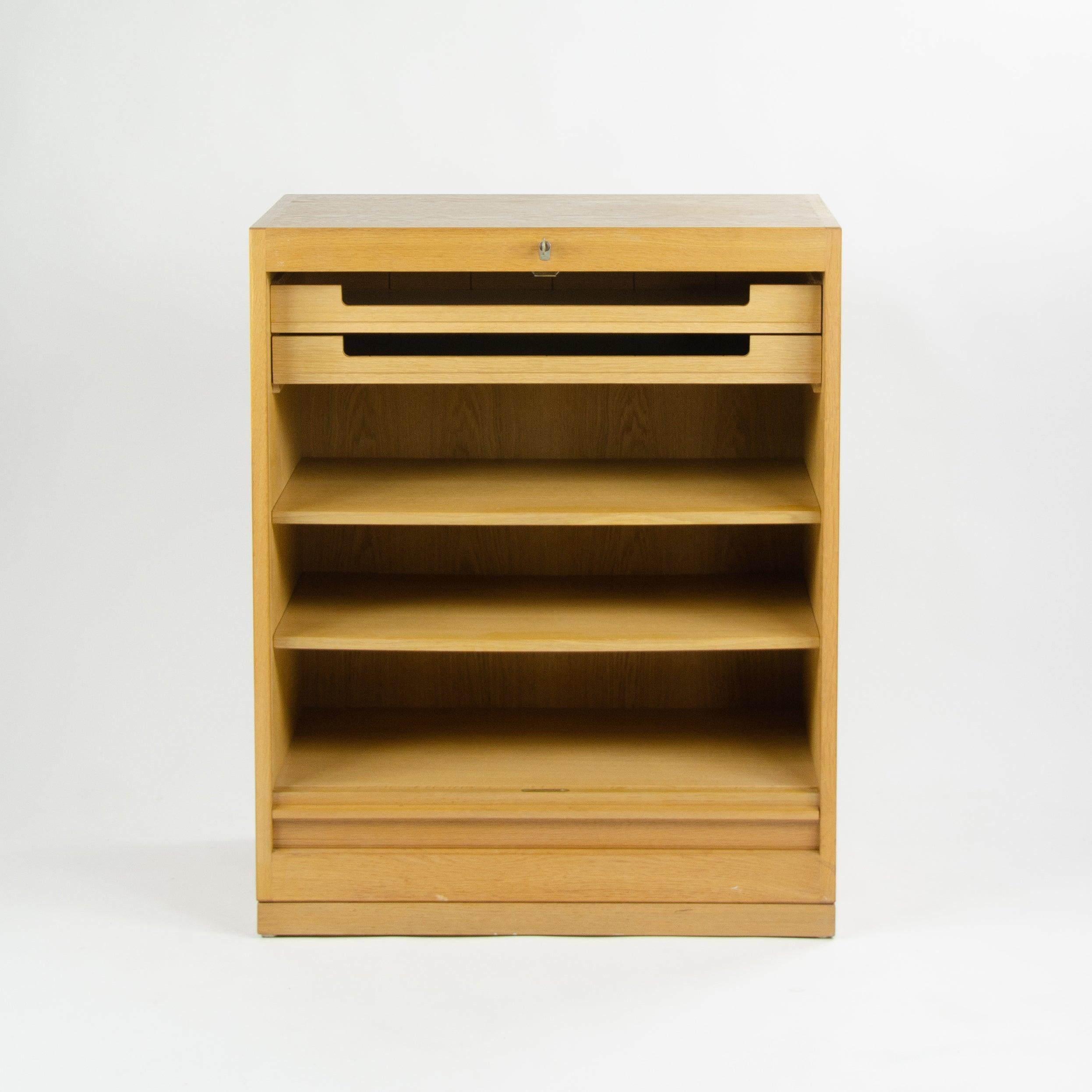 Listed for sale is a rare vintage Hans Wegner for Johannes Hansen of Denmark oak tambour storage unit/cabinet. This rare cabinet was part of a larger storage system, which allowed for the creation of fabulous modules for storage.


This example